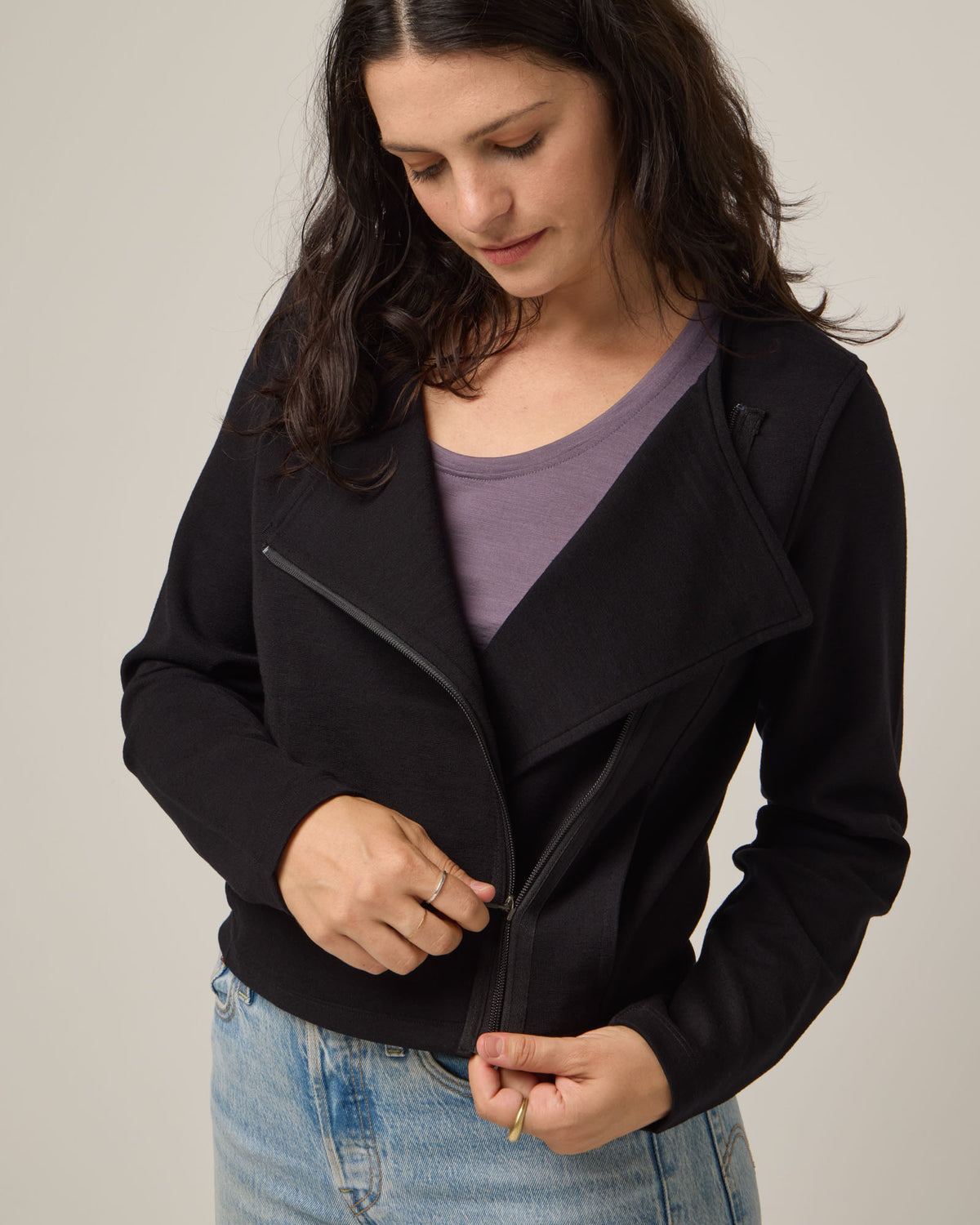 Model wearing Lou Moto Jacket in Black. Lou Moto Jacket is a merino wool jacket with pockets available in sizes XS-XXL.