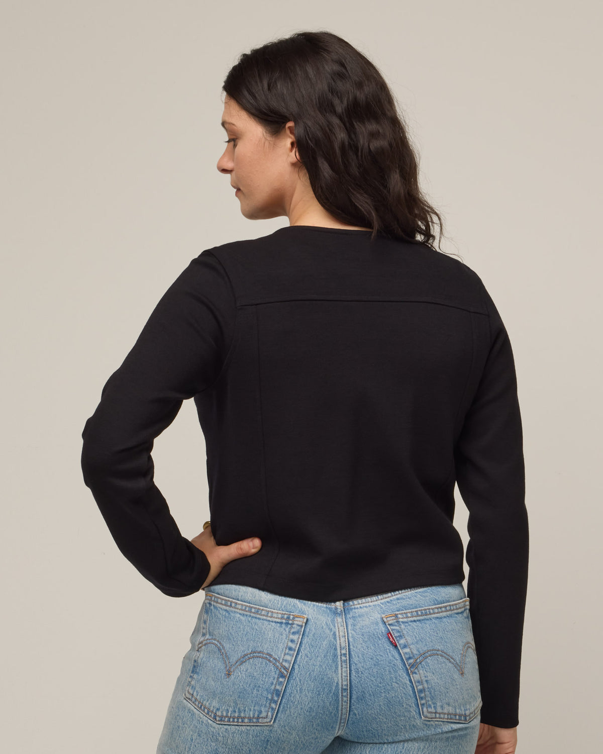 Model wearing Lou Moto Jacket in Black. Lou Moto Jacket is a merino wool jacket with pockets available in sizes XS-XXL.
