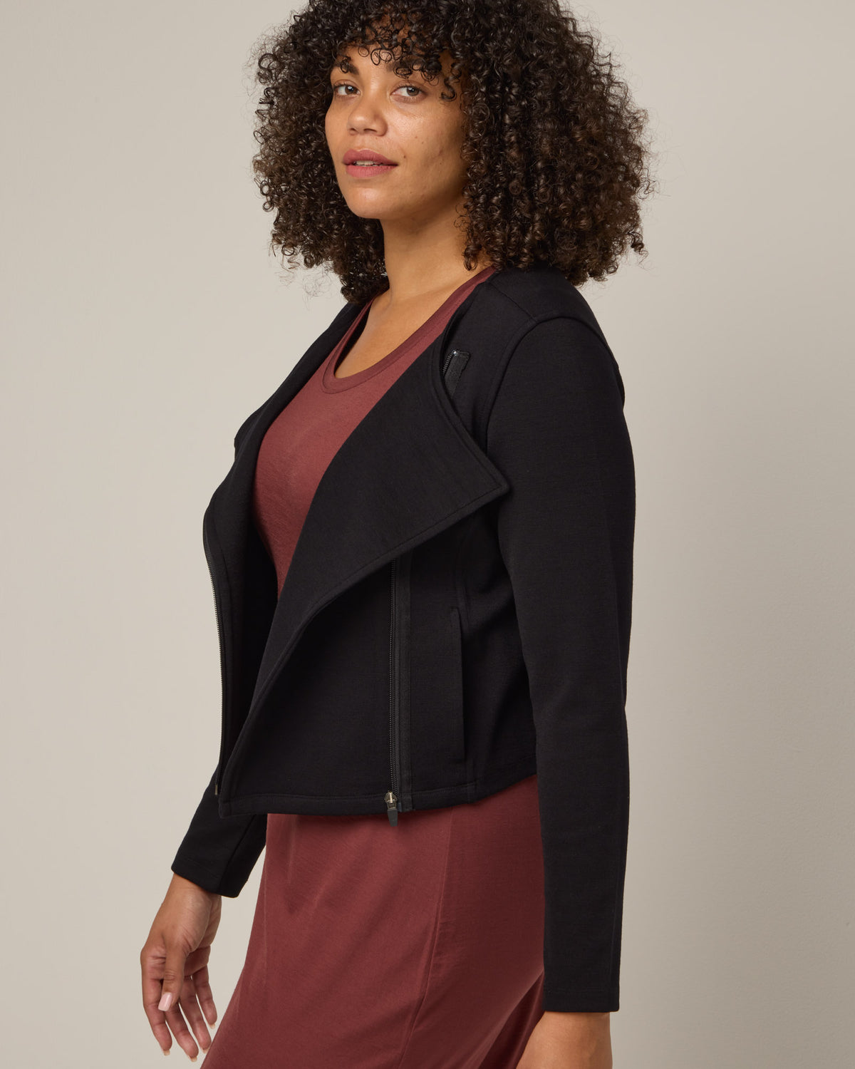 Model wearing Lou Moto Jacket in Black. Lou Moto Jacket is a merino wool jacket with pockets available in sizes XS-XXL.
