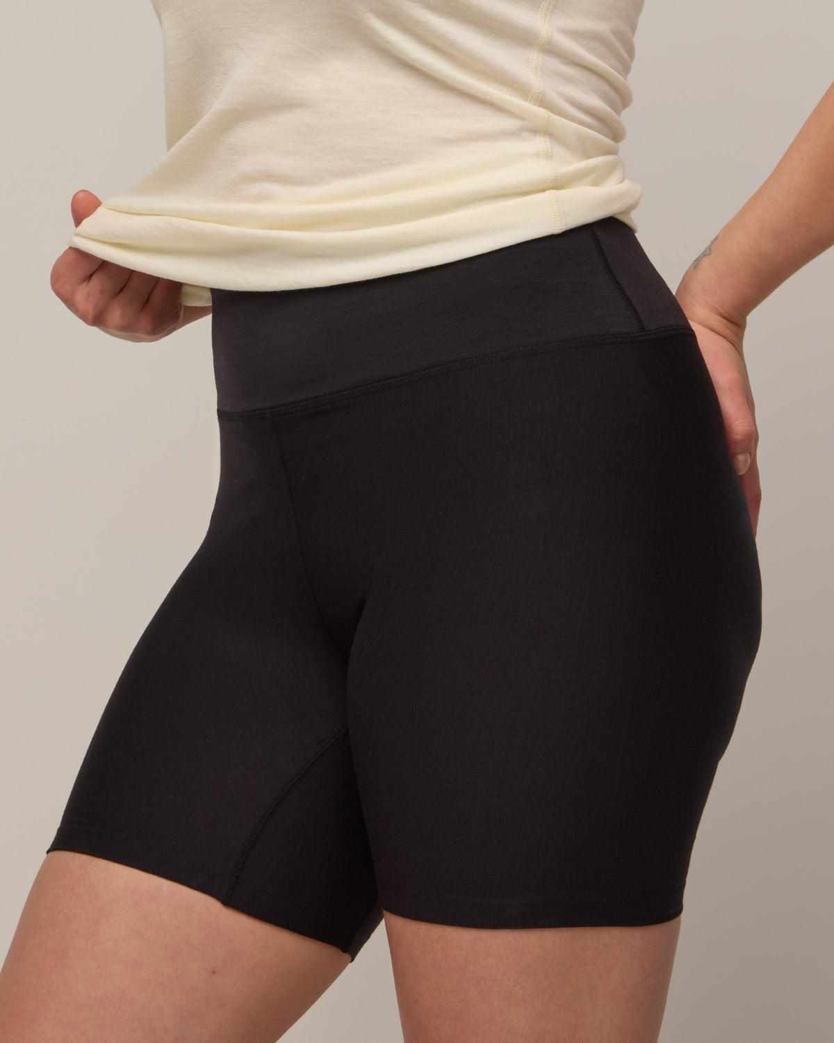 Model wearing Roam Bike Short in Black. Roam Bike Short is a merino wool short with pockets available in sizes XS-3X.