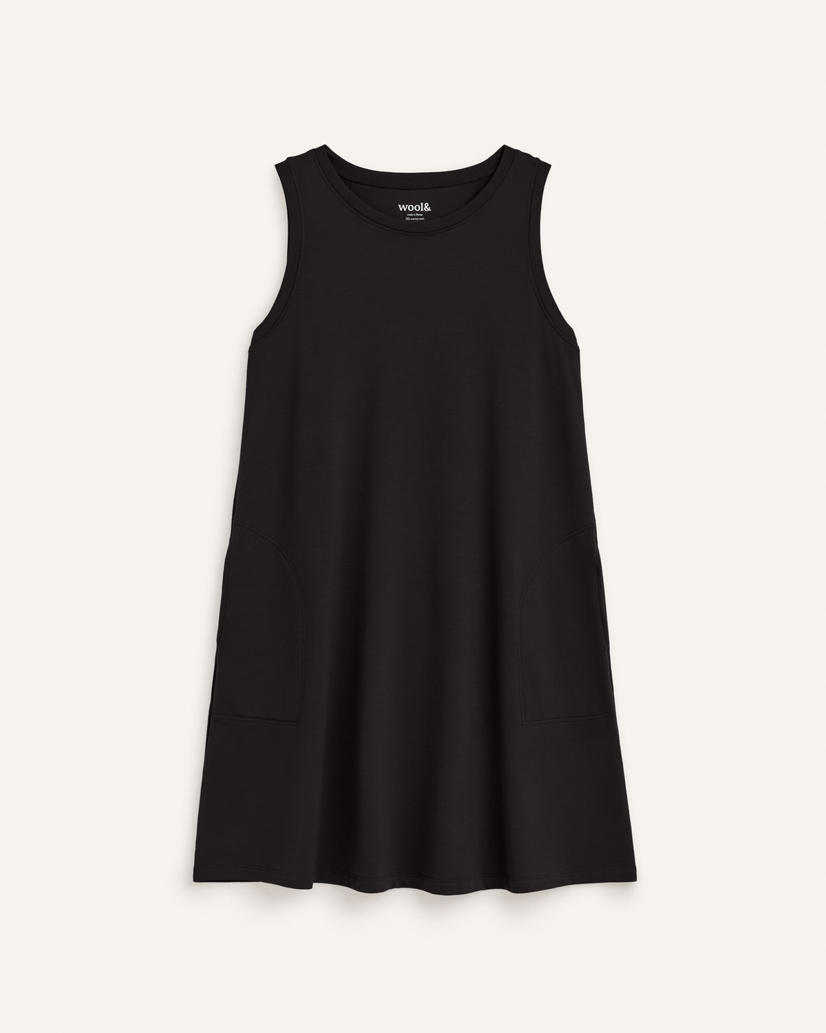 Laydown of Sierra Tank Dress in Black. Sierra Tank Dress is a merino wool sleeveless, crew neck, knee length swing dress with pockets available in sizes XS-3X Regular, XS-3X Long.