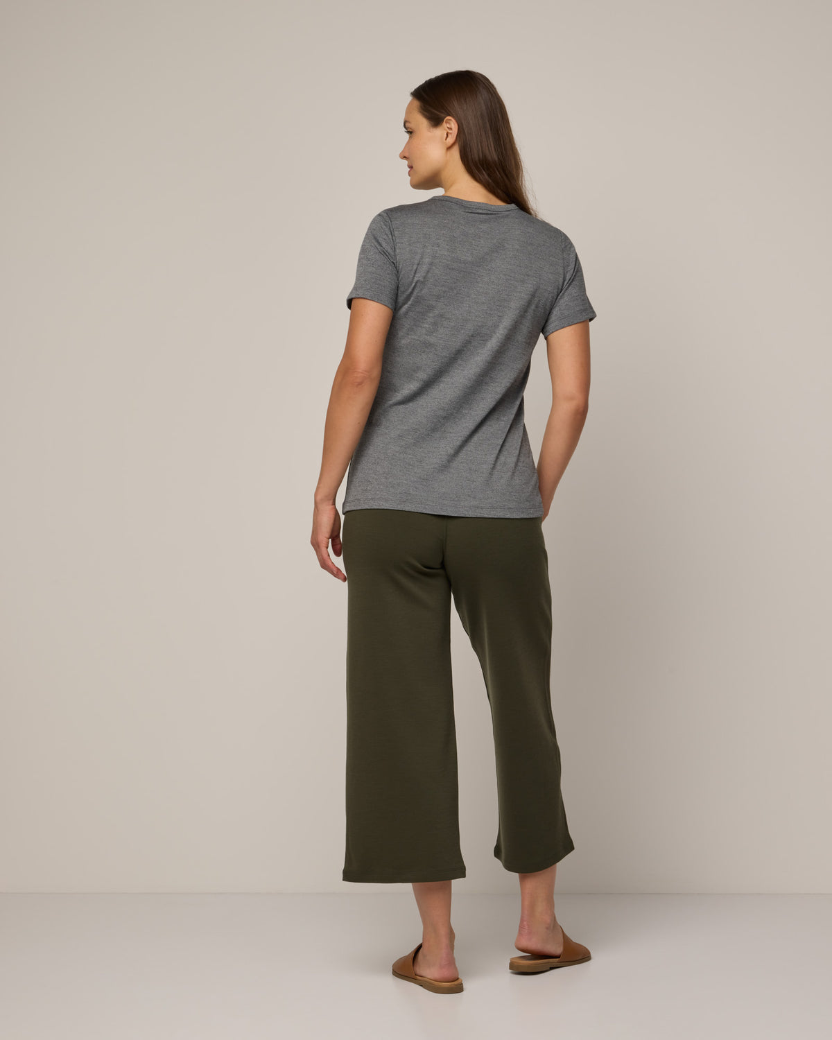Model wearing Cara Signature Fitted Tee in Charcoal Heather. Cara Signature Fitted Tee is a merino wool short sleeve, crew neck, slim fit tee available in sizes XS-3X.