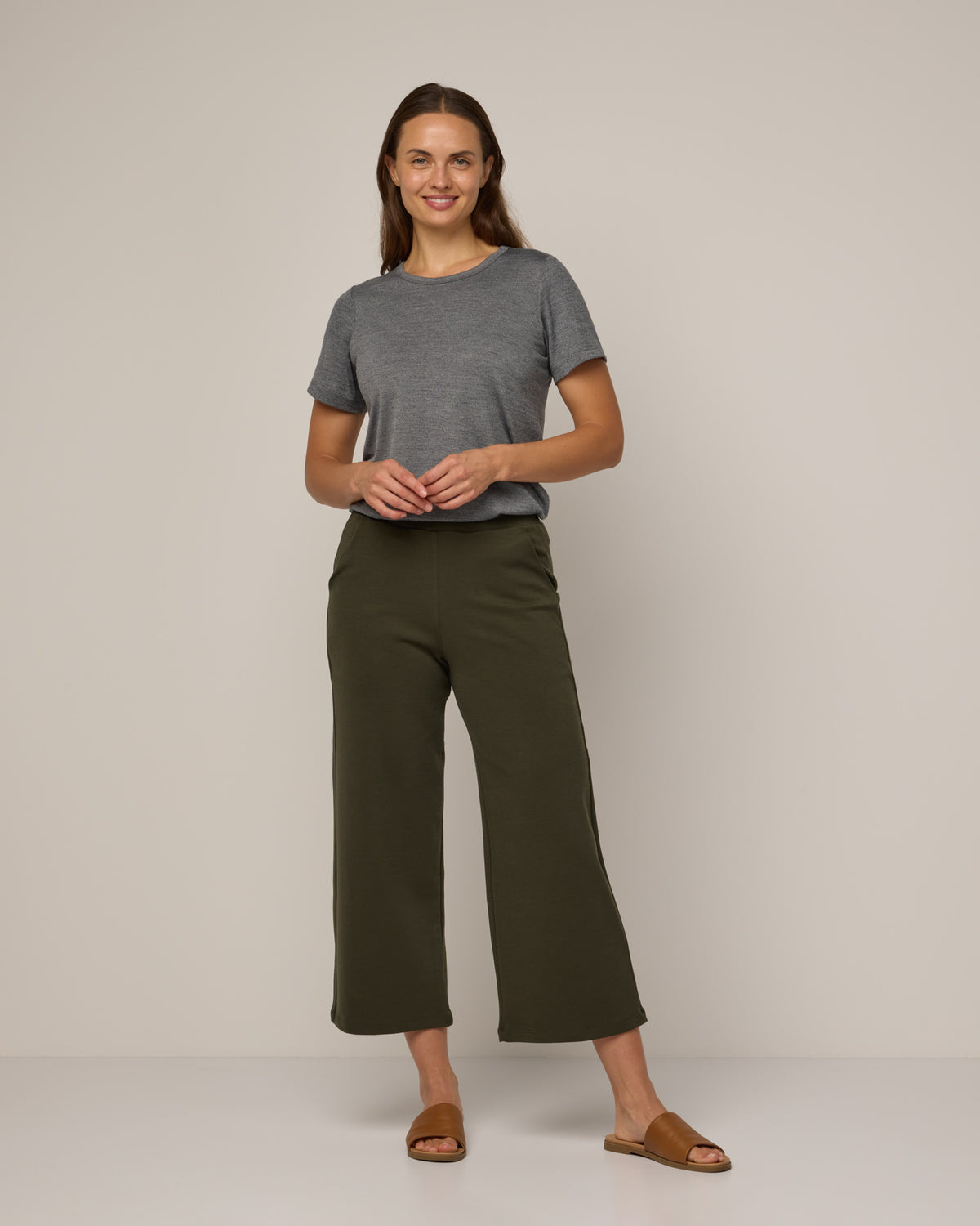 Model wearing Cara Signature Fitted Tee in Charcoal Heather. Cara Signature Fitted Tee is a merino wool short sleeve, crew neck, slim fit tee available in sizes XS-3X.