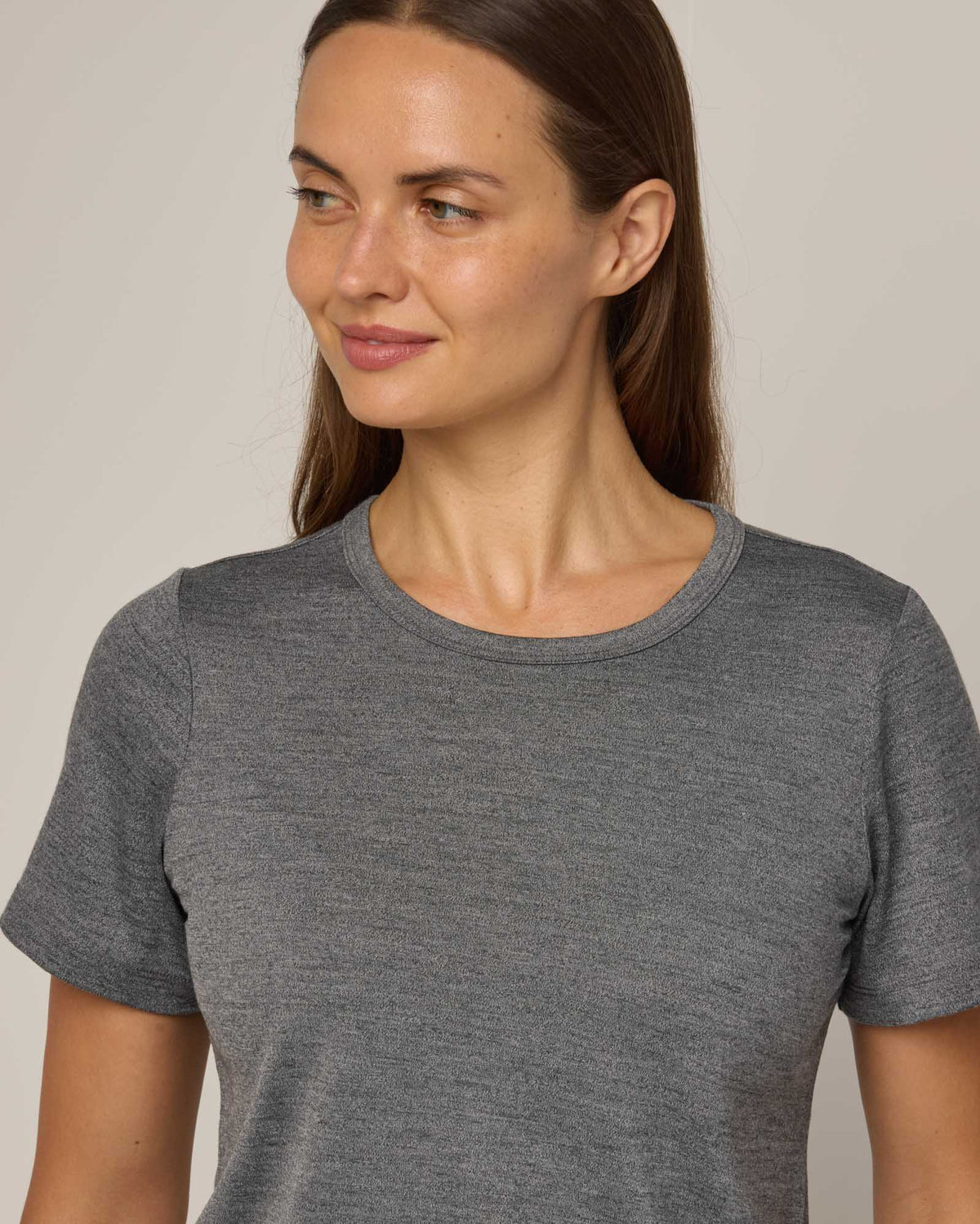Model wearing Cara Signature Fitted Tee in Charcoal Heather. Cara Signature Fitted Tee is a merino wool short sleeve, crew neck, slim fit tee available in sizes XS-3X.
