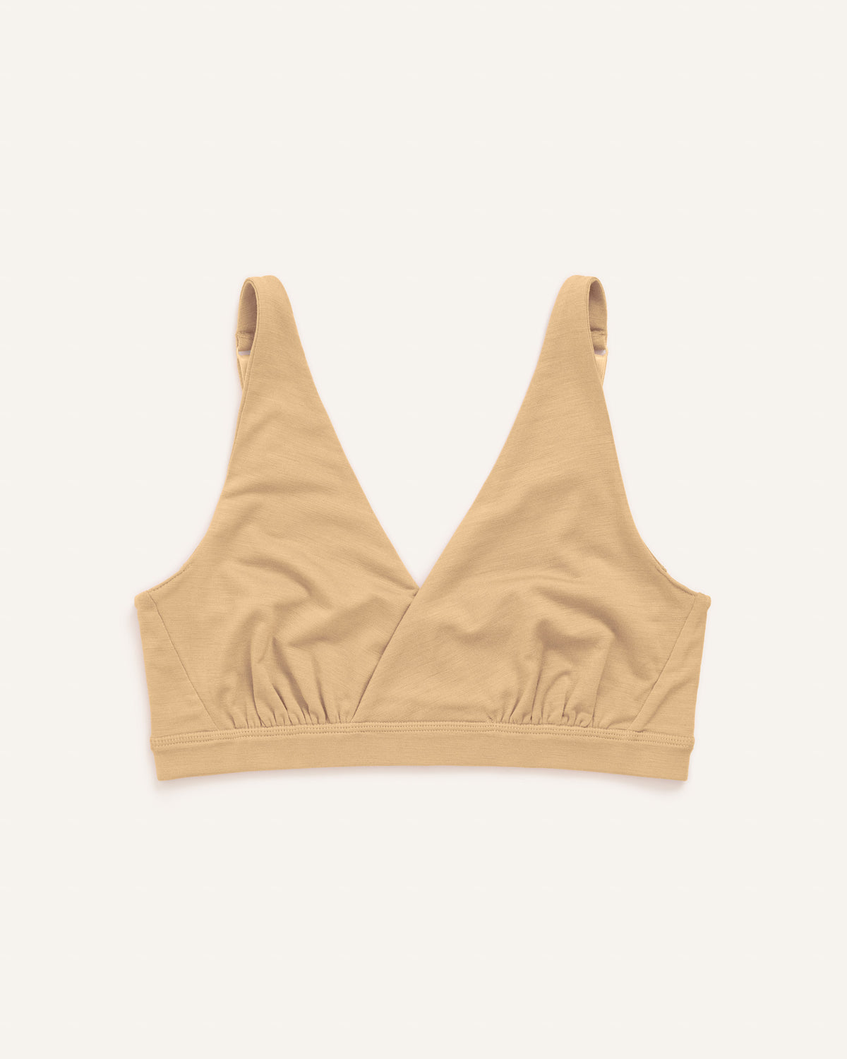 Laydown of Roam Convertible Wrap Bra in Fawn, a light nude color. Roam Convertible Wrap Bra is a merino wool underwear available in sizes XS-XXL.