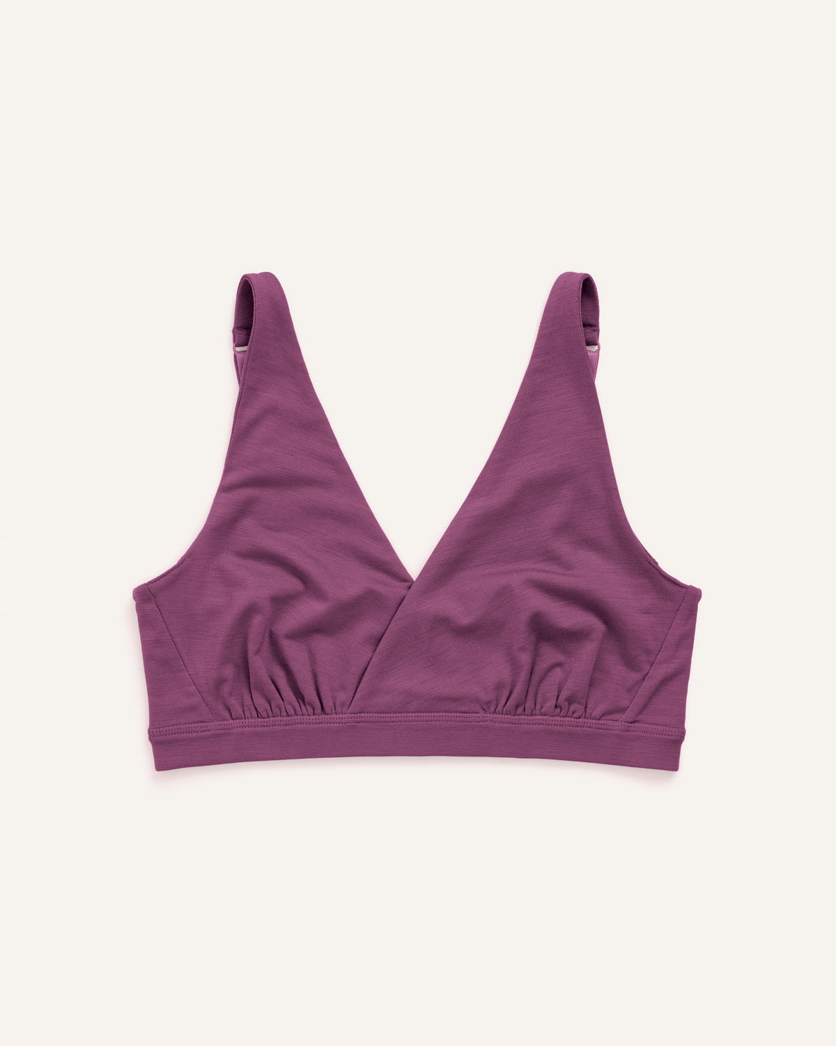 Laydown of Roam Convertible Wrap Bra in Plum, a berry pink-purple color. Roam Convertible Wrap Bra is a merino wool underwear available in sizes XS-XXL.