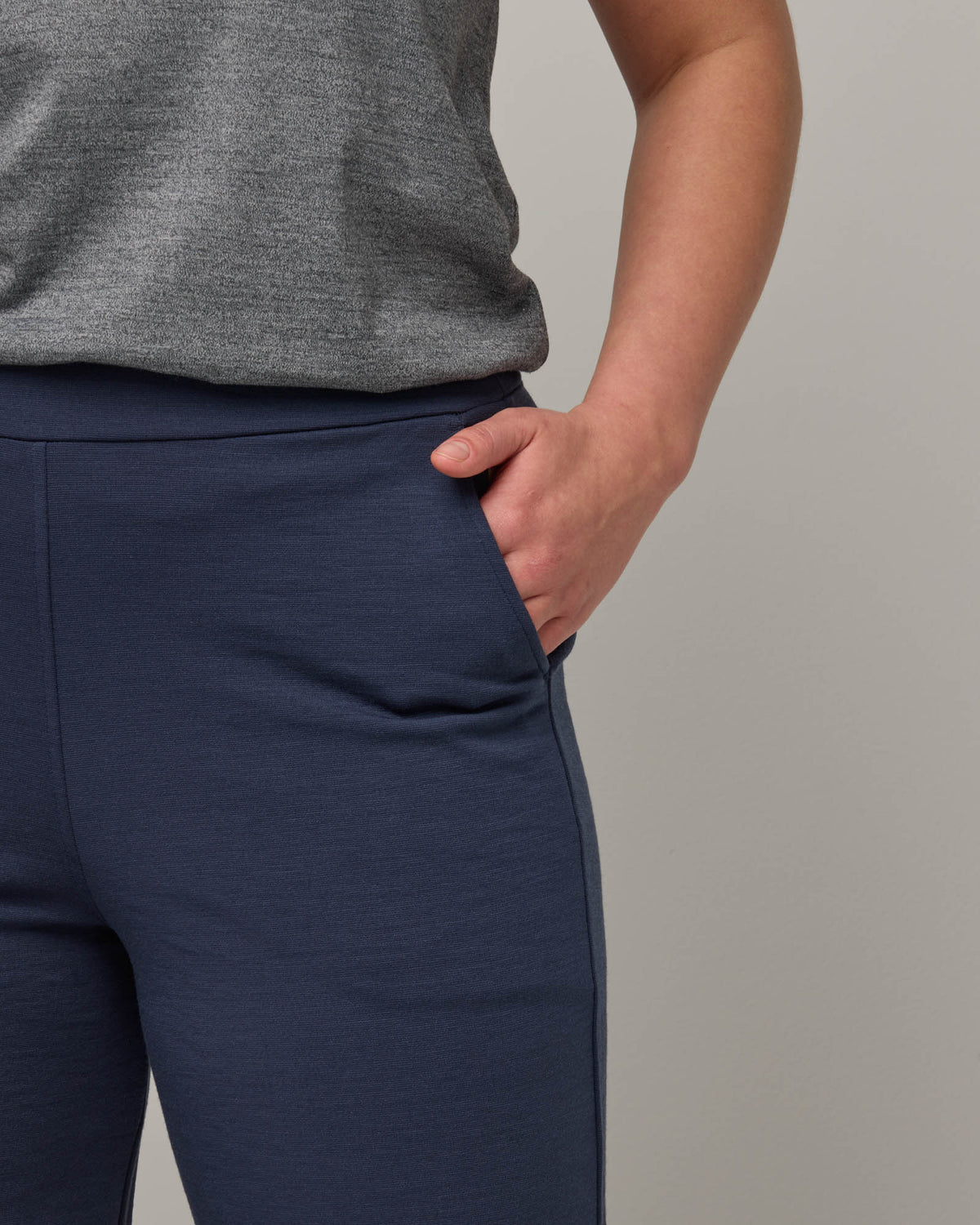 Model wearing Frame Ponte Culotte in Washed Navy. Frame Ponte Culotte is a merino wool pant with pockets available in sizes XS-3X Regular, XS-XL Petite.