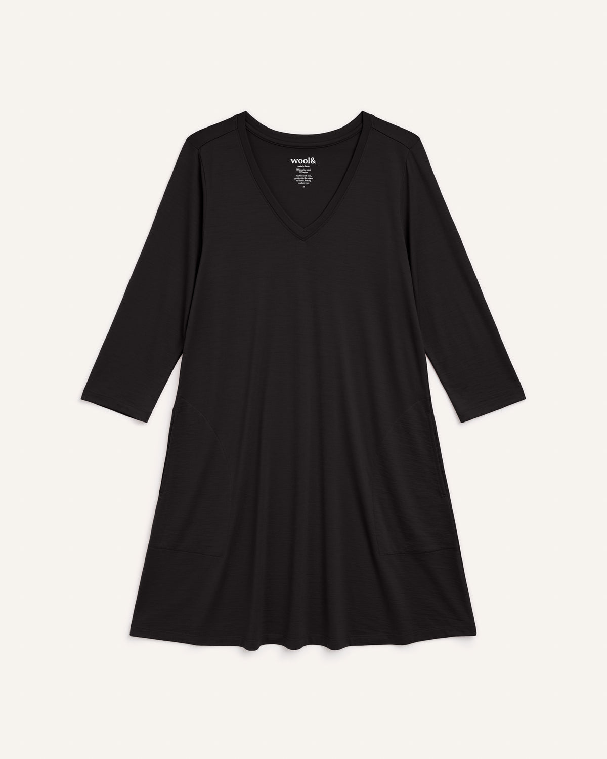 Laydown of Willow Swing Dress in Black. Willow Swing Dress is a merino wool long sleeve, v-neck, knee length swing dress with pockets available in sizes XS-3X Regular, XS-3X Long.