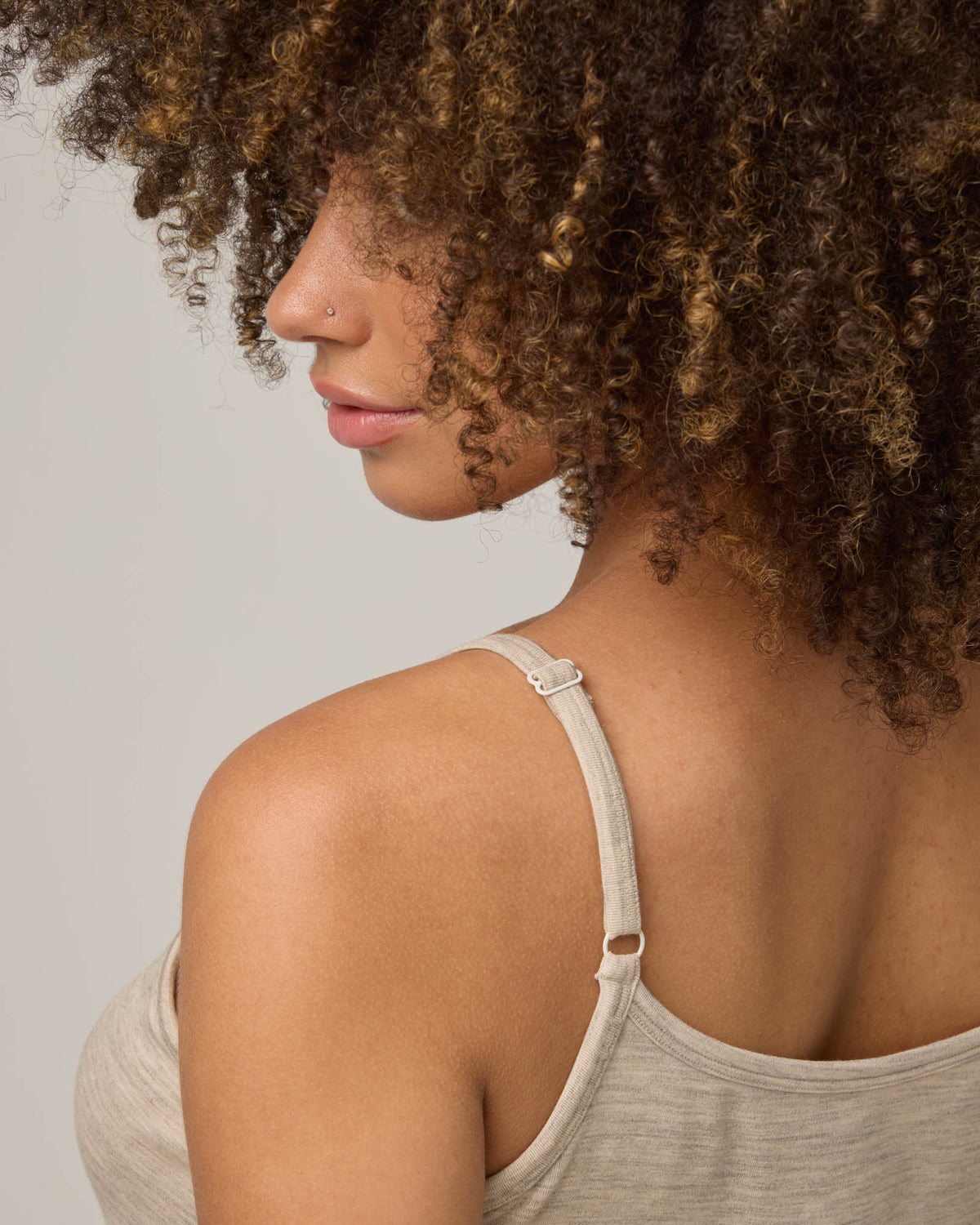 Model wearing Roam Cami Slip in Oatmeal Heather, a soft heathered cream color. Roam Cami Slip is a merino wool sleeveless, scoop neck, knee length fitted underwear available in sizes XS-3X.