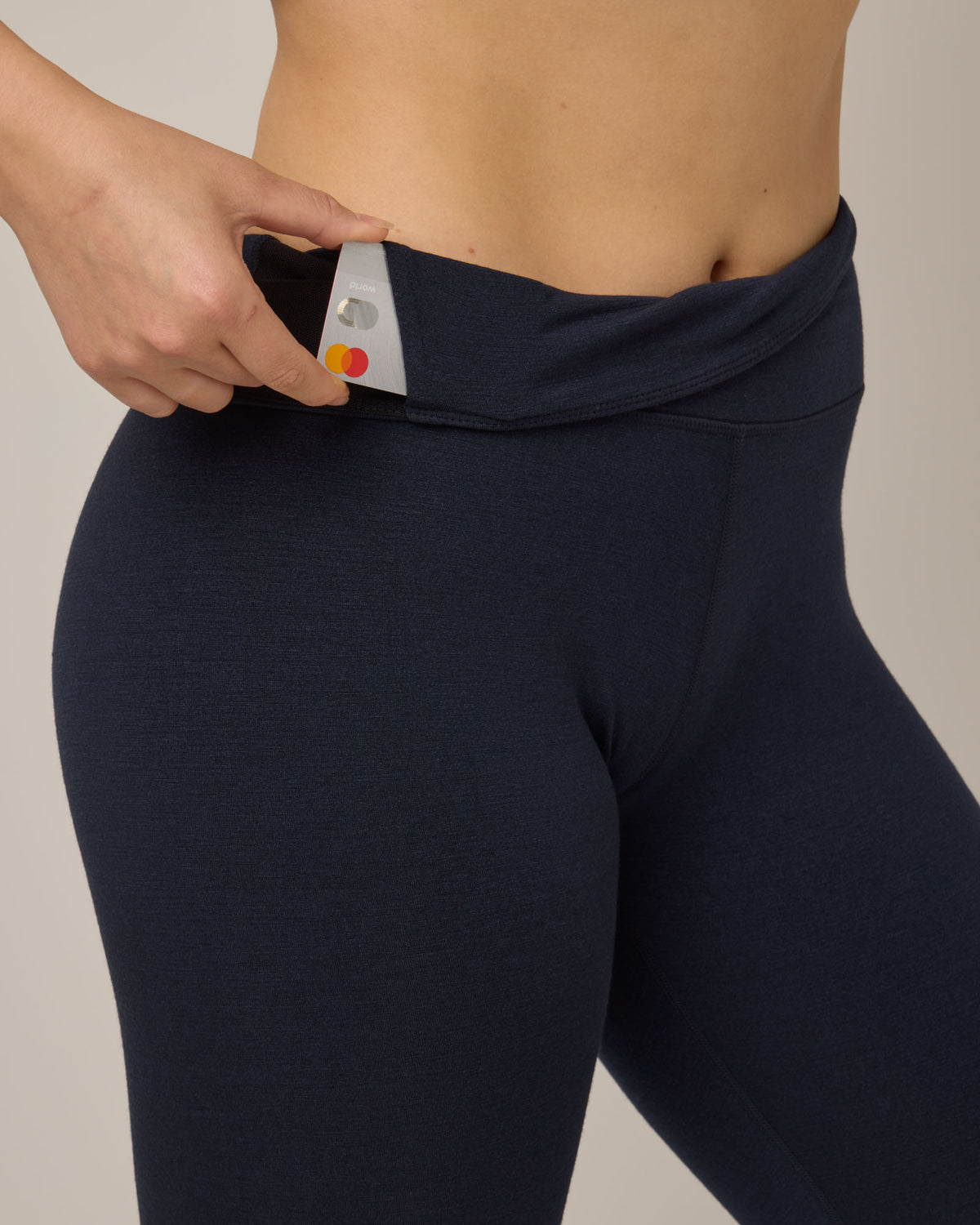 Model wearing Summit Legging in Navy. Summit Legging is a merino wool legging available in sizes XS-3X Regular, S-XXL Long.