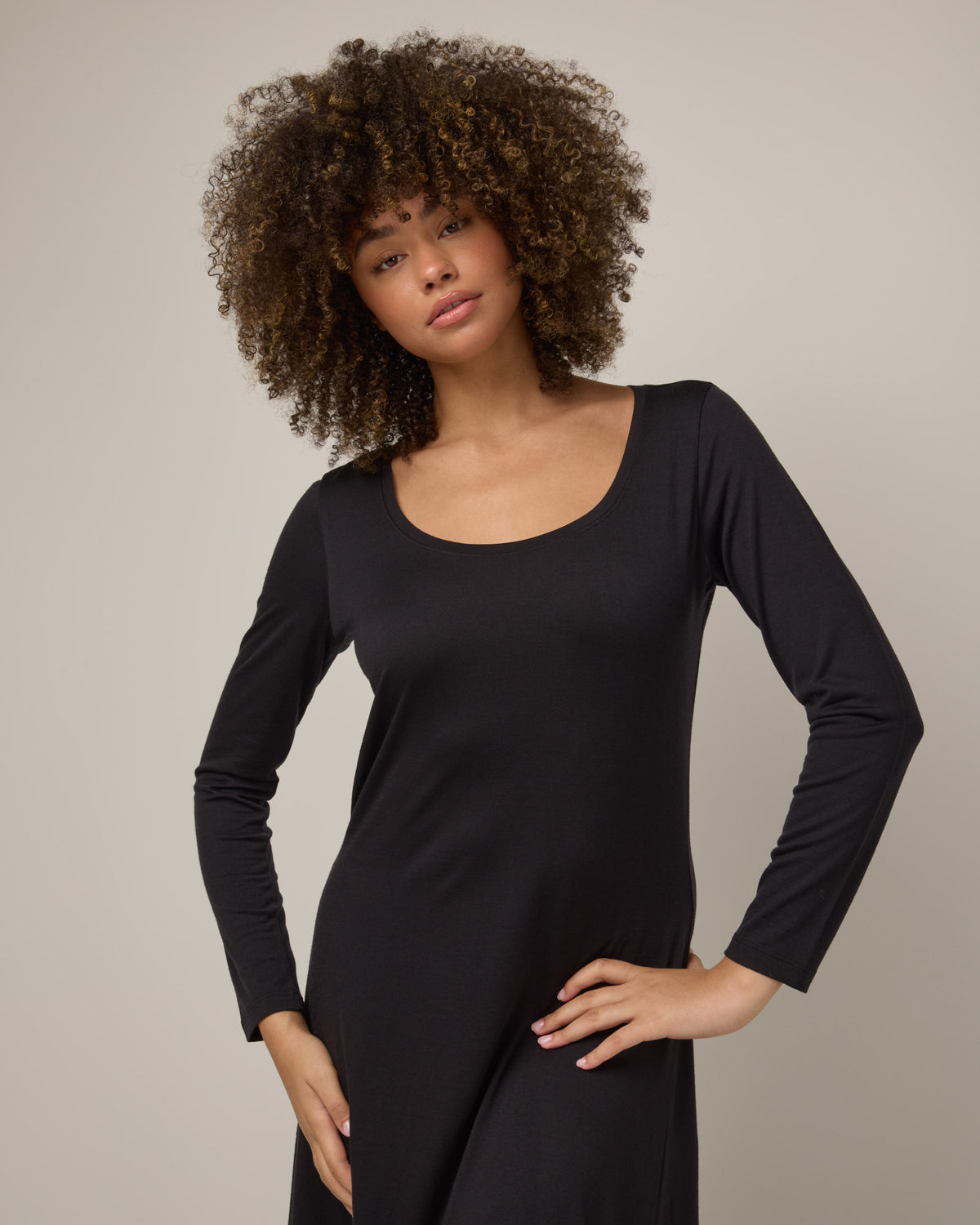 Model wearing Valerie Maxi Dress in Black. Valerie Maxi Dress is a merino wool long sleeve, scoop neck, maxi swing dress available in sizes XS-XXL.