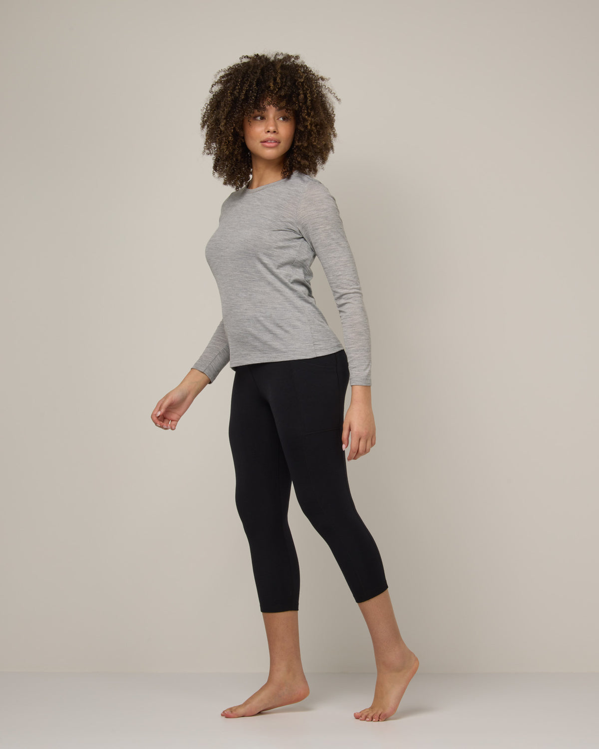 Model wearing Summit Pocket Crop Legging in Black. Summit Pocket Crop Legging is a merino wool legging with pockets available in sizes XS-3X.