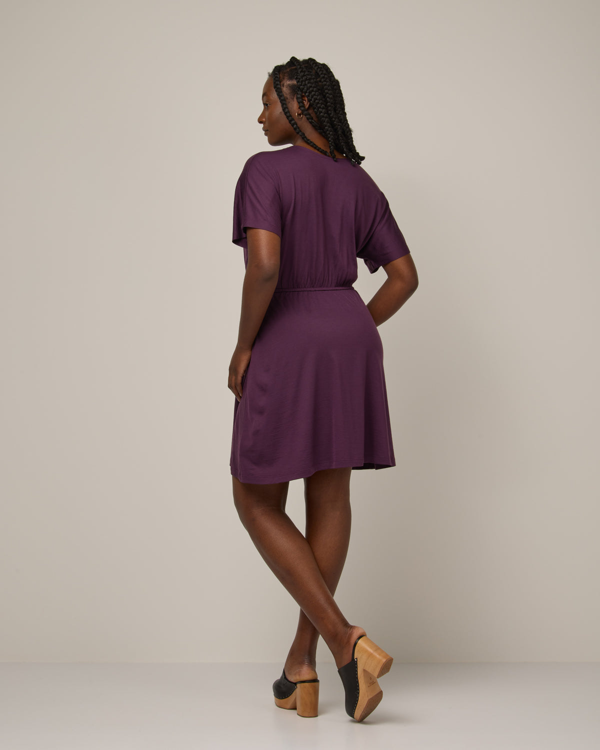 Model wearing Brooklyn Reversible Dress in Marionberry, a dark berry purple color. Brooklyn Reversible Dress is a merino wool short sleeve, reversible, knee length fit & flare dress with pockets available in sizes XS-3X Regular, XS-XL Long.