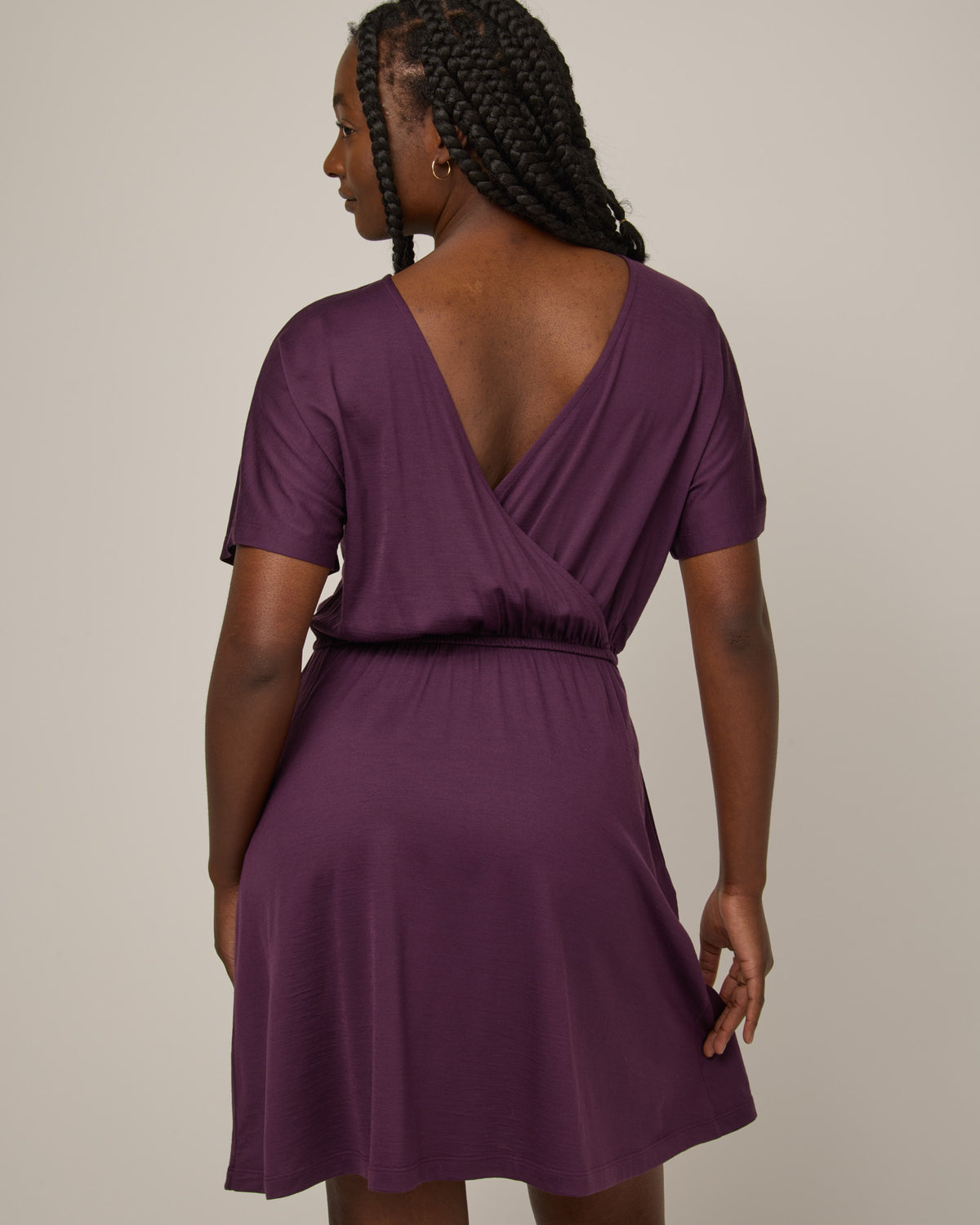Model wearing Brooklyn Reversible Dress in Marionberry, a dark berry purple color. Brooklyn Reversible Dress is a merino wool short sleeve, reversible, knee length fit & flare dress with pockets available in sizes XS-3X Regular, XS-XL Long.