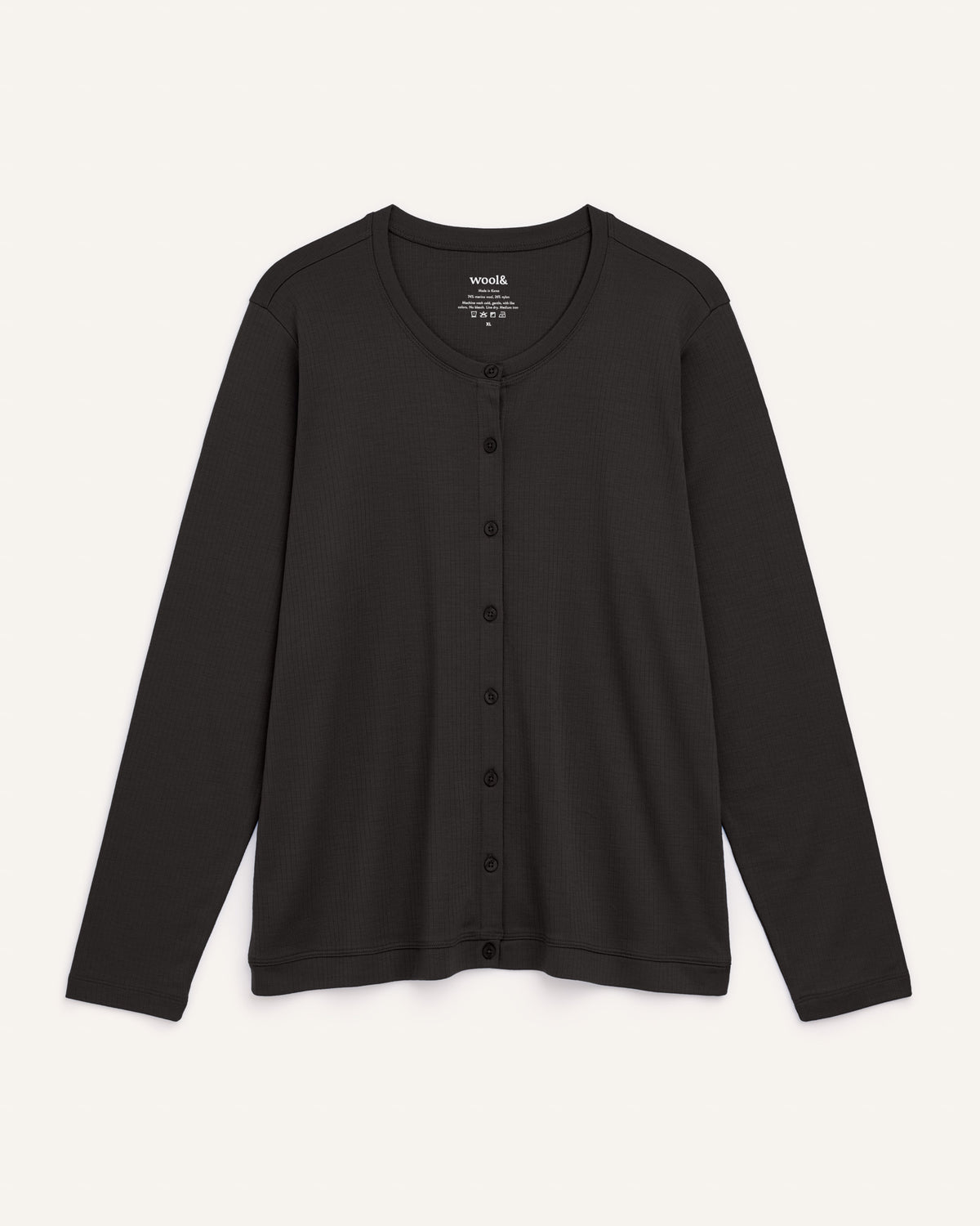 Laydown of Celeste Ribbed Cardigan in Black. Celeste Ribbed Cardigan is a merino wool long sleeve, cardigan available in sizes XS-3X.