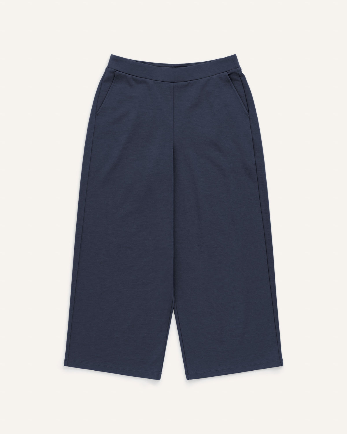 Laydown of Frame Ponte Culotte in Washed Navy. Frame Ponte Culotte is a merino wool pant with pockets available in sizes XS-3X Regular, XS-XL Petite.