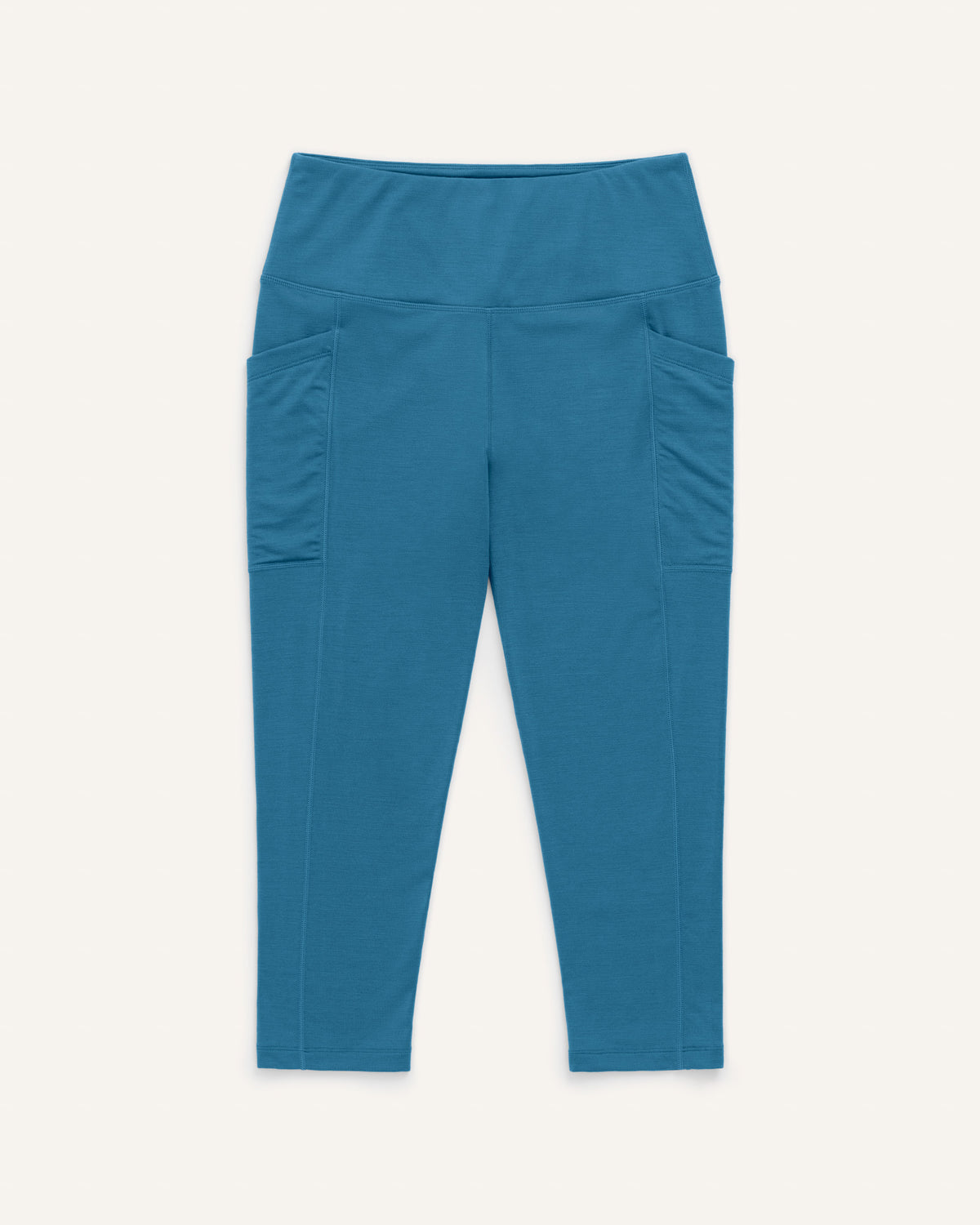 Laydown of Summit Pocket Crop Legging in Ocean Teal, a medium blue-green color. Summit Pocket Crop Legging is a merino wool legging with pockets available in sizes XS-3X.