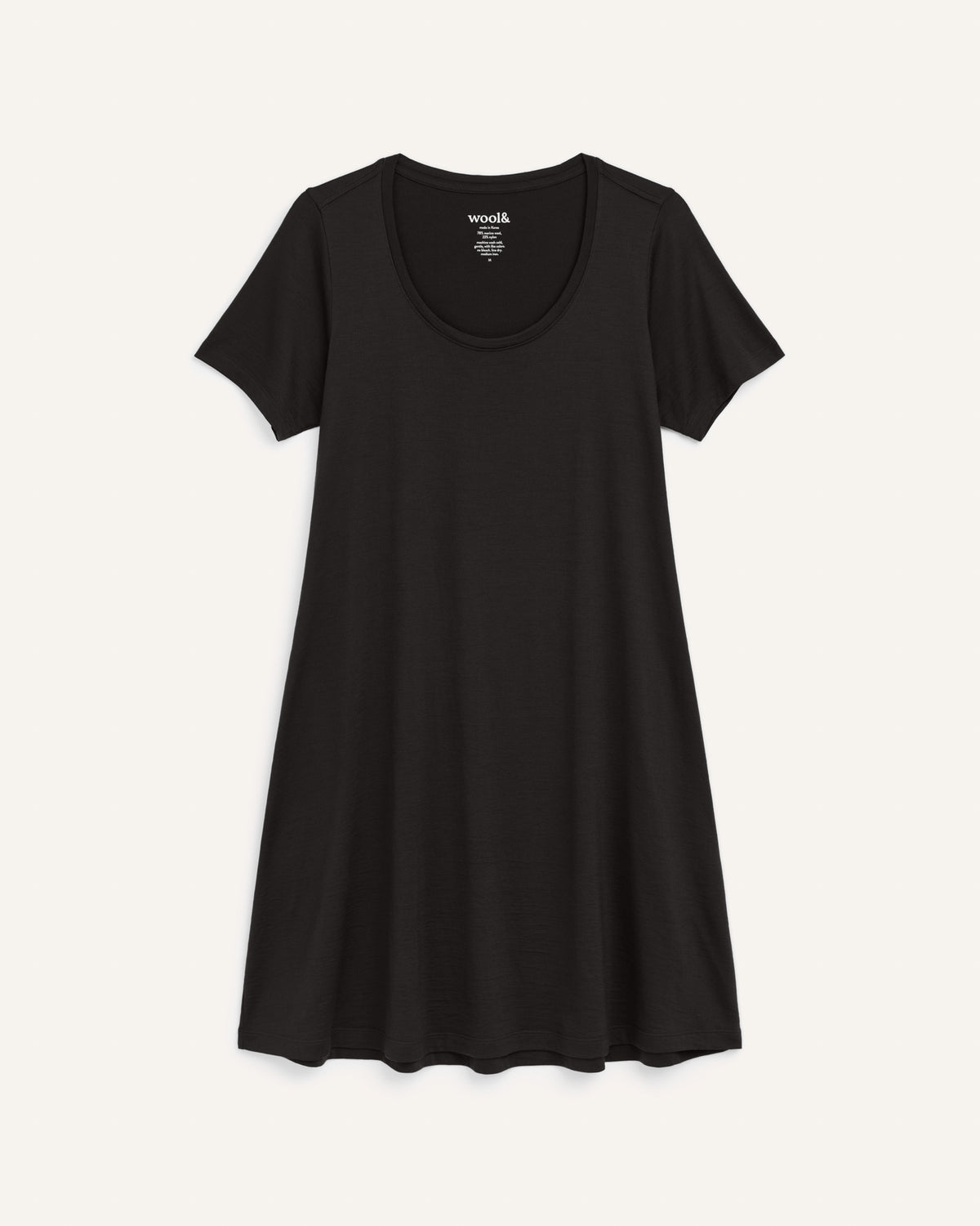 Laydown of Maggie Swing Dress in Black. Maggie Swing Dress is a merino wool short sleeve, scoop neck, knee length swing dress with pockets available in sizes XS-3X Regular, XS-3X Long.