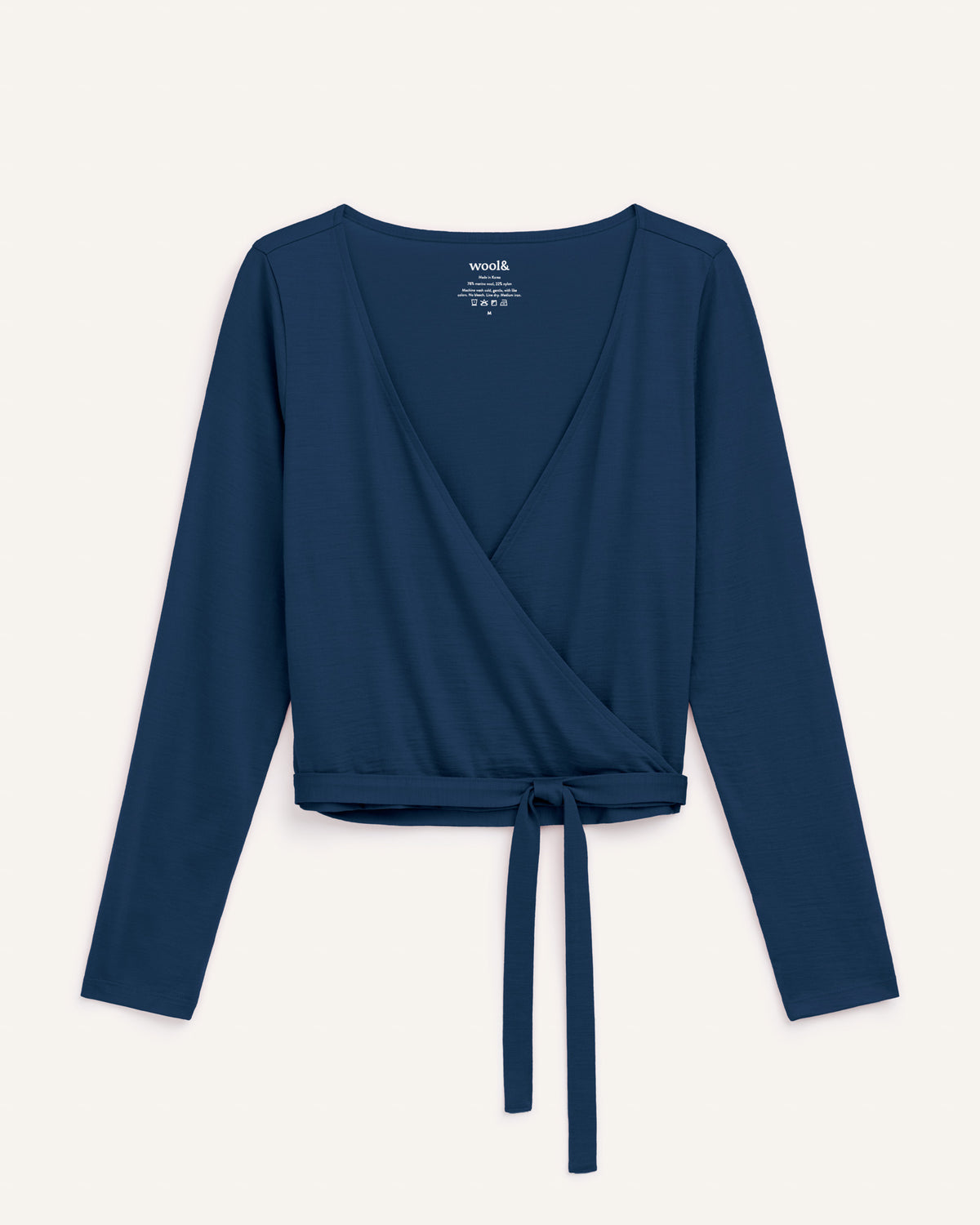 Laydown of Natalia Wrap Top in Marine Blue, a deep royal blue color. Natalia Wrap Top is a merino wool long sleeve, v-neck, slim fit top available in sizes XS-3X.