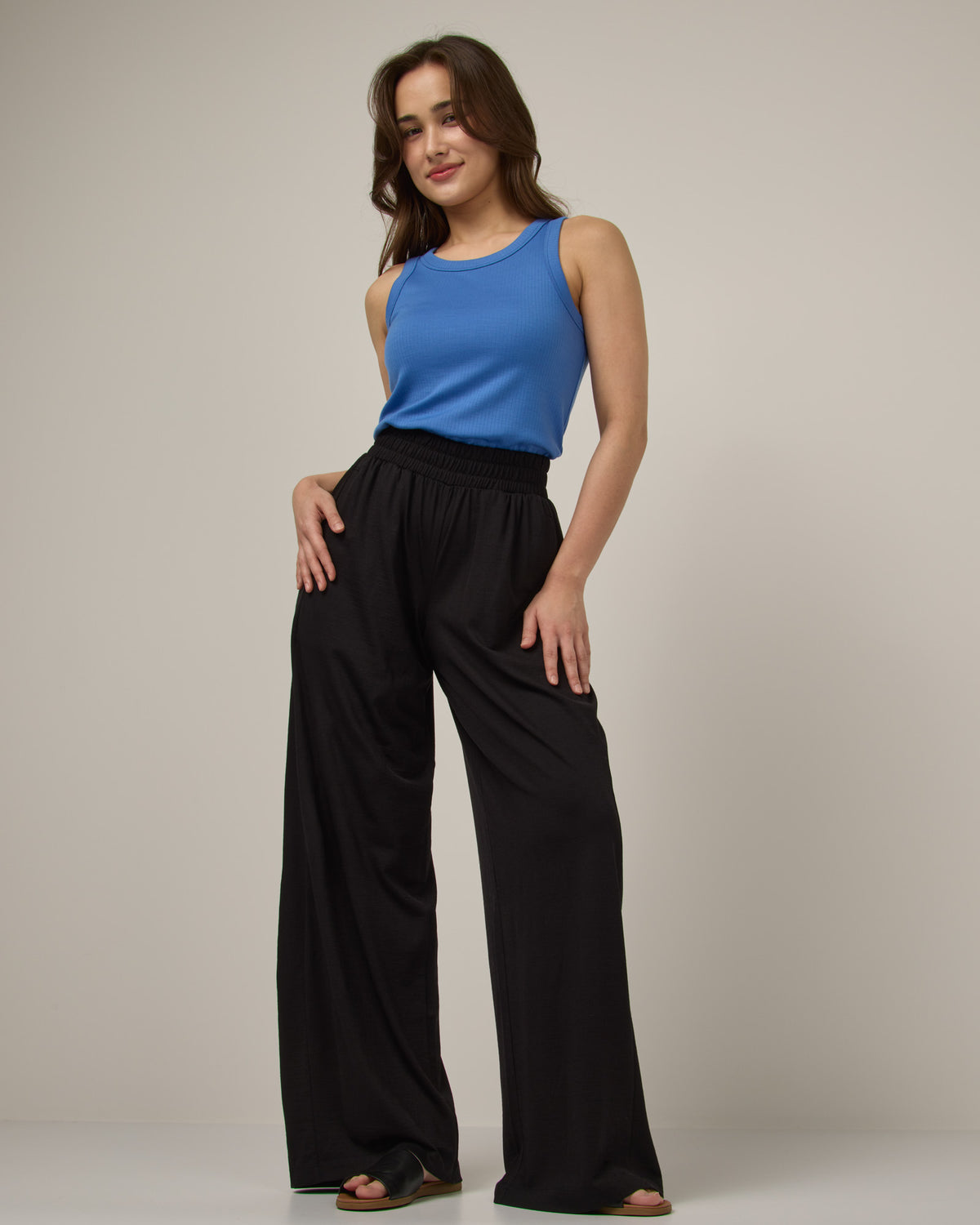 Model wearing Lisbon Palazzo Pant in Black. Lisbon Palazzo Pant is a merino wool pant available in sizes XS-3X.