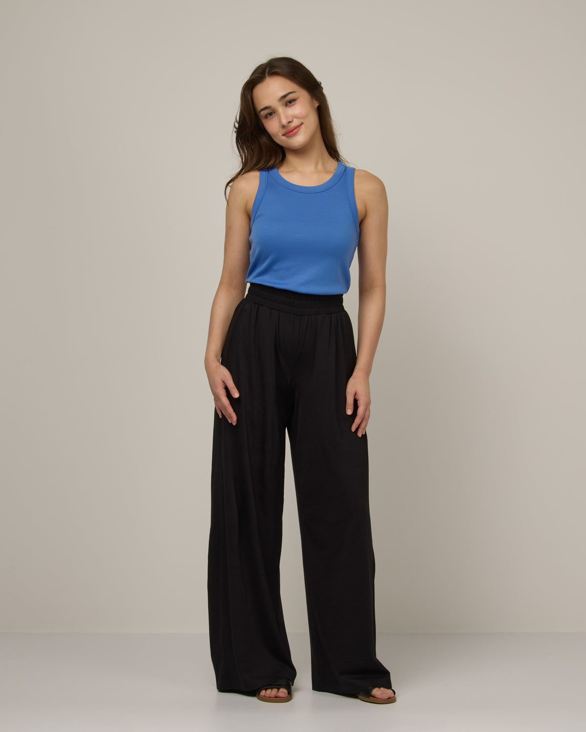 Model wearing Lisbon Palazzo Pant in Black. Lisbon Palazzo Pant is a merino wool pant available in sizes XS-3X.