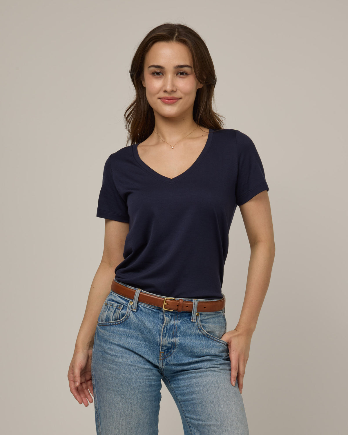 Model wearing Morgan V-Neck Tee in Washed Navy. Morgan V-Neck Tee is a merino wool short sleeve, v-neck, regular fit tee available in sizes XS-3X.