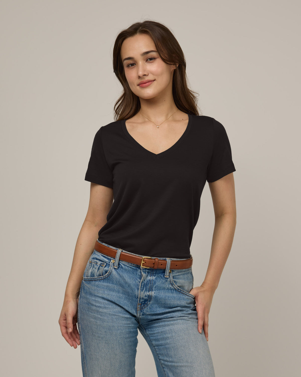 Model wearing Morgan V-Neck Tee in Black. Morgan V-Neck Tee is a merino wool short sleeve, v-neck, regular fit tee available in sizes XS-3X.