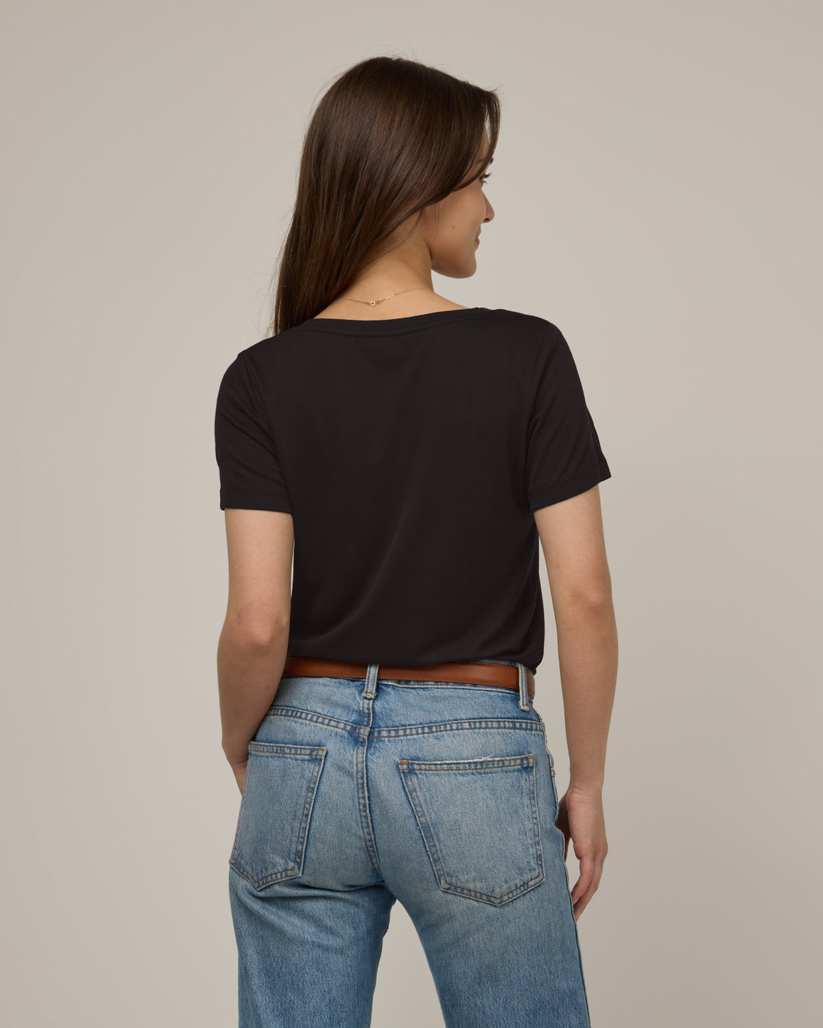 Model wearing Morgan V-Neck Tee in Black. Morgan V-Neck Tee is a merino wool short sleeve, v-neck, regular fit tee available in sizes XS-3X.