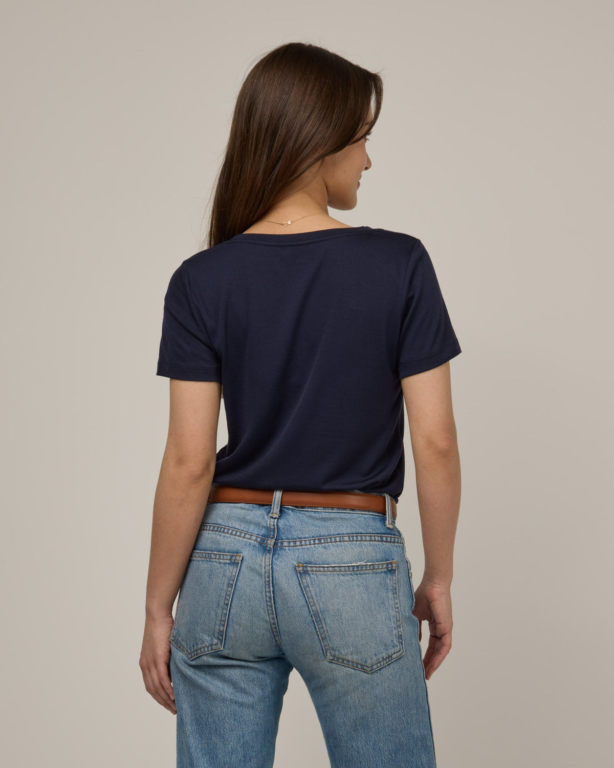 Model wearing Morgan V-Neck Tee in Washed Navy. Morgan V-Neck Tee is a merino wool short sleeve, v-neck, regular fit tee available in sizes XS-3X.
