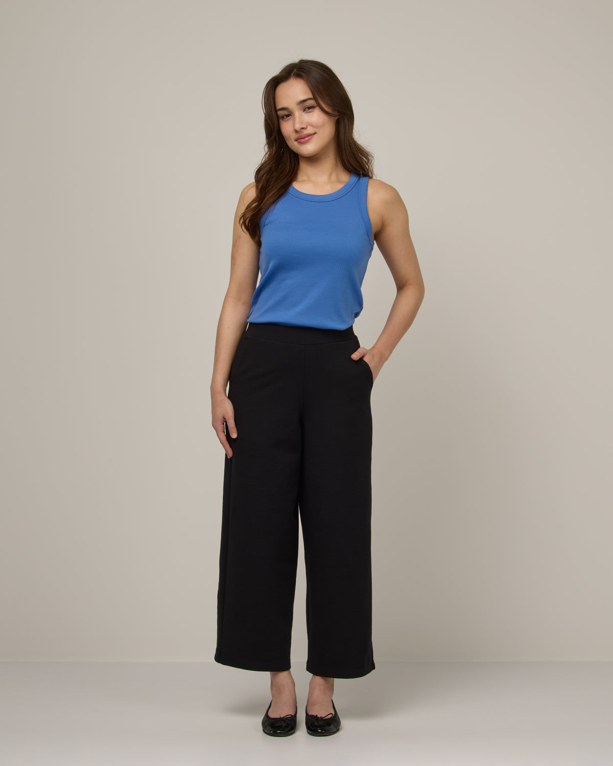 Model wearing Frame Ponte Culotte in Black. Frame Ponte Culotte is a merino wool pant with pockets available in sizes XS-3X Regular, XS-XL Petite.