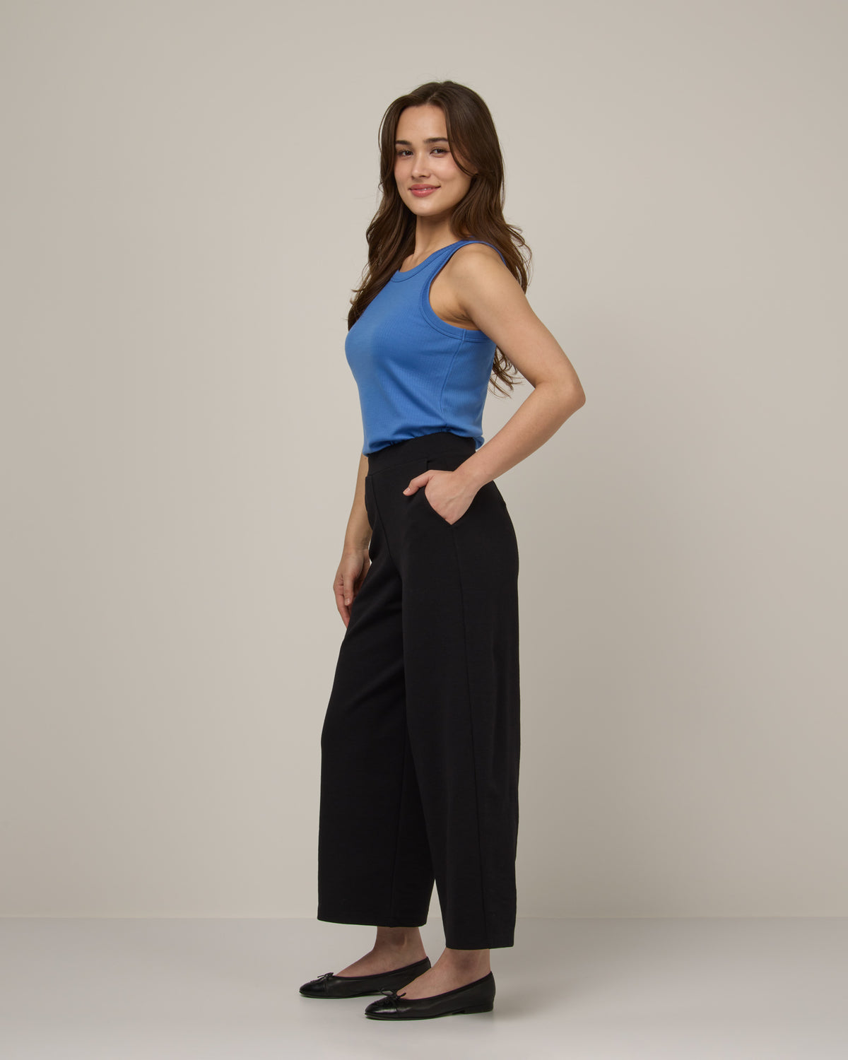 Model wearing Frame Ponte Culotte in Black. Frame Ponte Culotte is a merino wool pant with pockets available in sizes XS-3X Regular, XS-XL Petite.
