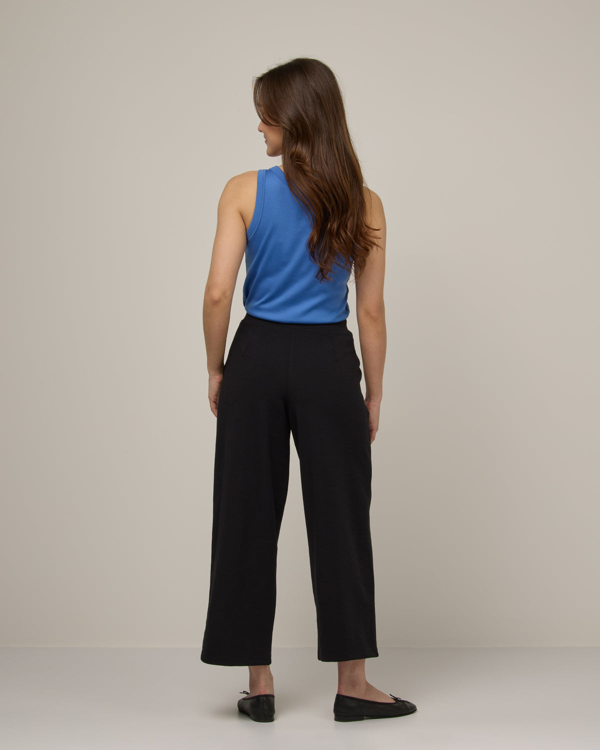 Model wearing Frame Ponte Culotte in Black. Frame Ponte Culotte is a merino wool pant with pockets available in sizes XS-3X Regular, XS-XL Petite.