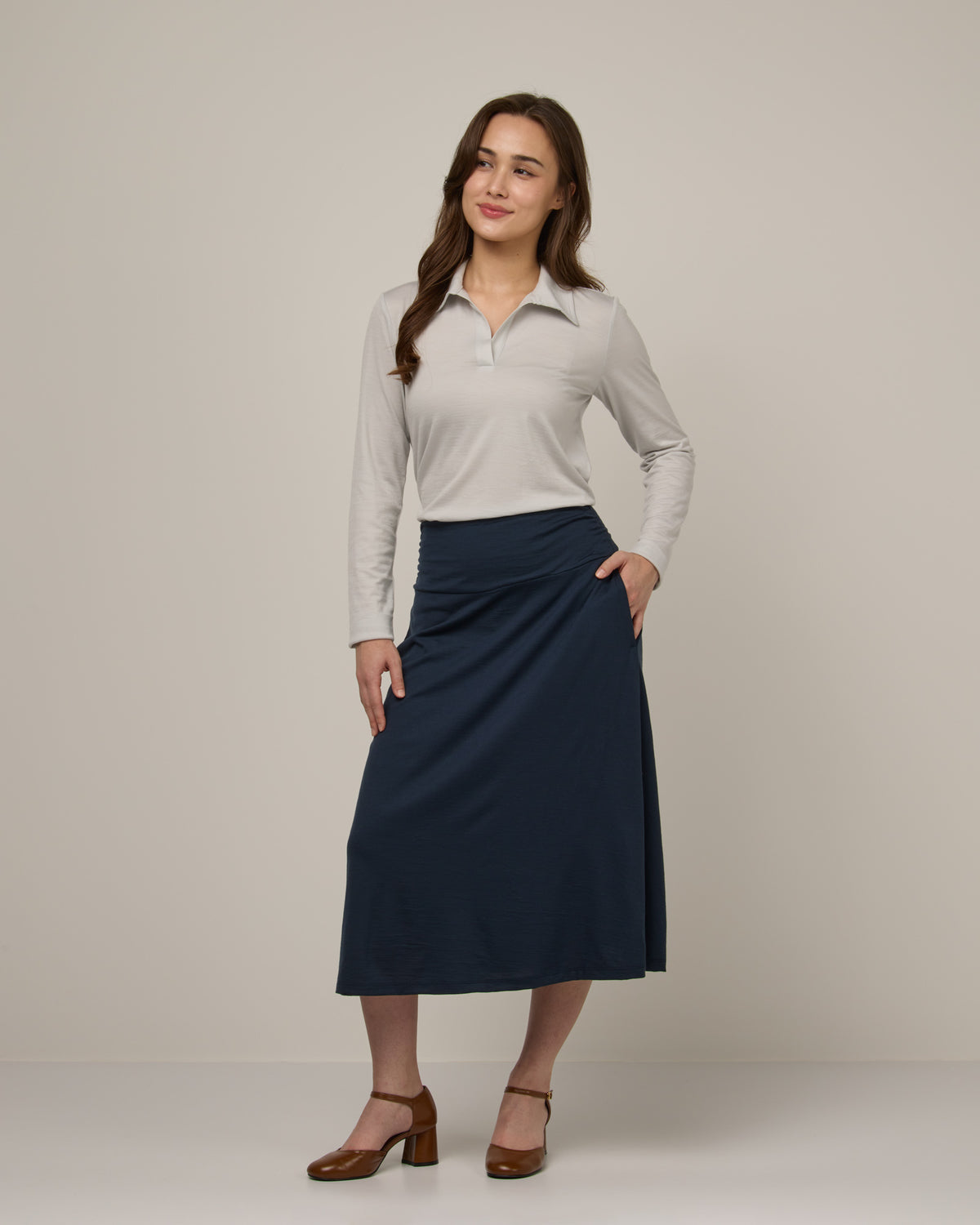 Model wearing Helena Midi Skirt in Washed Navy. Helena Midi Skirt is a merino wool midi skirt with pockets available in sizes XS-3X.