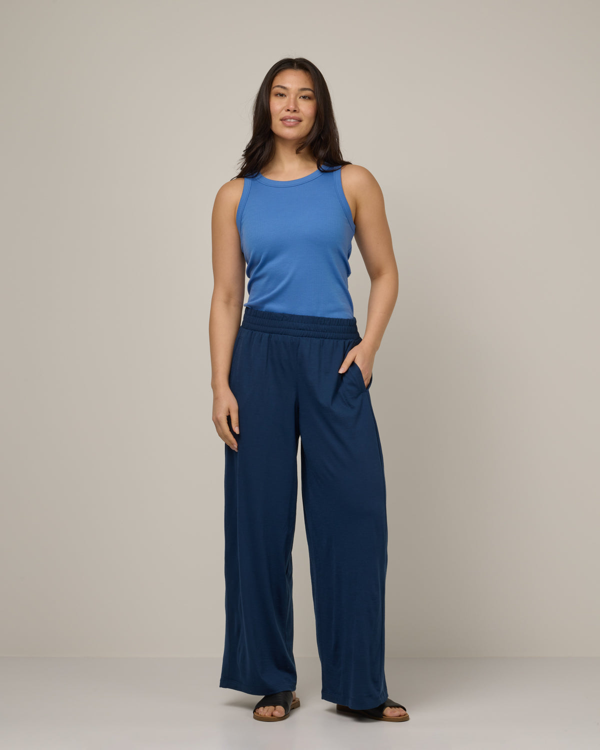 Model wearing Lisbon Palazzo Pant in Marine Blue, a deep royal blue color. Lisbon Palazzo Pant is a merino wool pant available in sizes XS-3X.