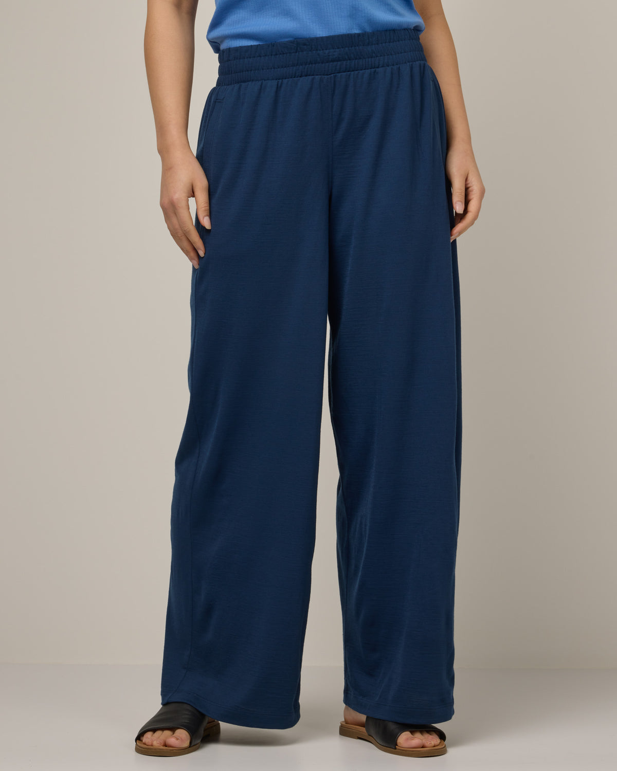 Model wearing Lisbon Palazzo Pant in Marine Blue, a deep royal blue color. Lisbon Palazzo Pant is a merino wool pant available in sizes XS-3X.