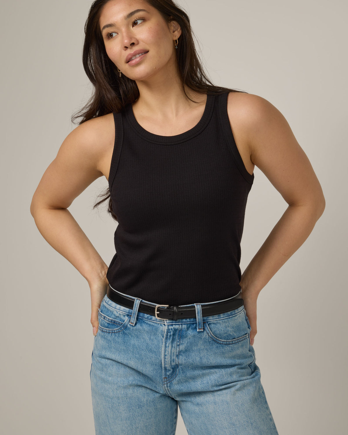 Model wearing Lily Ribbed Tank in Black. Lily Ribbed Tank is a merino wool sleeveless, crew neck, slim fit top available in sizes XS-3X.