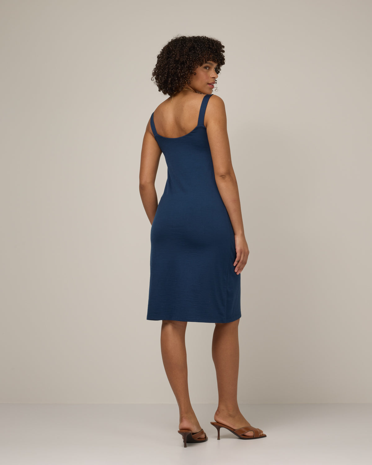 Model wearing Tessa Shelf Bra Dress in Marine Blue, a deep royal blue color. Tessa Shelf Bra Dress is a merino wool sleeveless, v-neck, knee length fitted dress available in sizes XS-XXL.