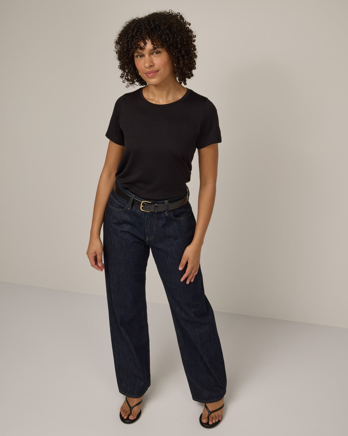 Model wearing Zoe Easy Crew Neck Tee in Black. Zoe Easy Crew Neck Tee is a merino wool short sleeve, crew neck, regular fit tee available in sizes XS-3X.