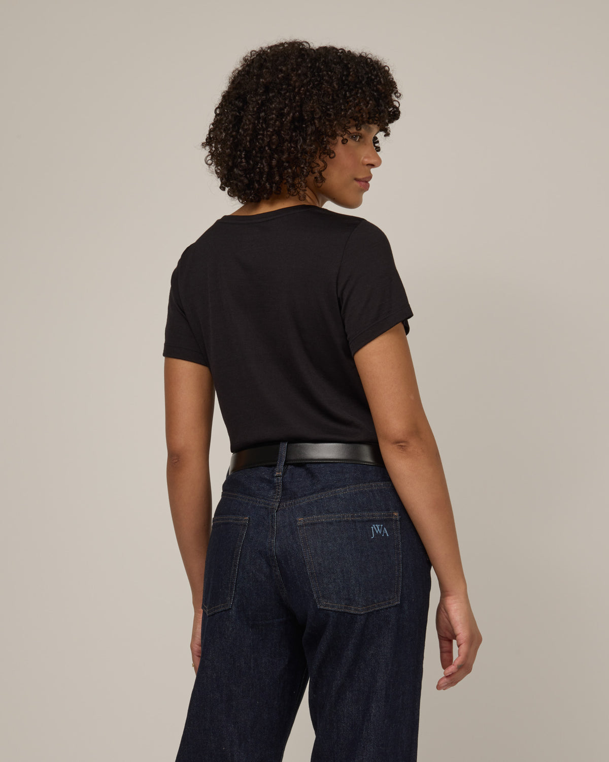 Model wearing Zoe Easy Crew Neck Tee in Black. Zoe Easy Crew Neck Tee is a merino wool short sleeve, crew neck, regular fit tee available in sizes XS-3X.