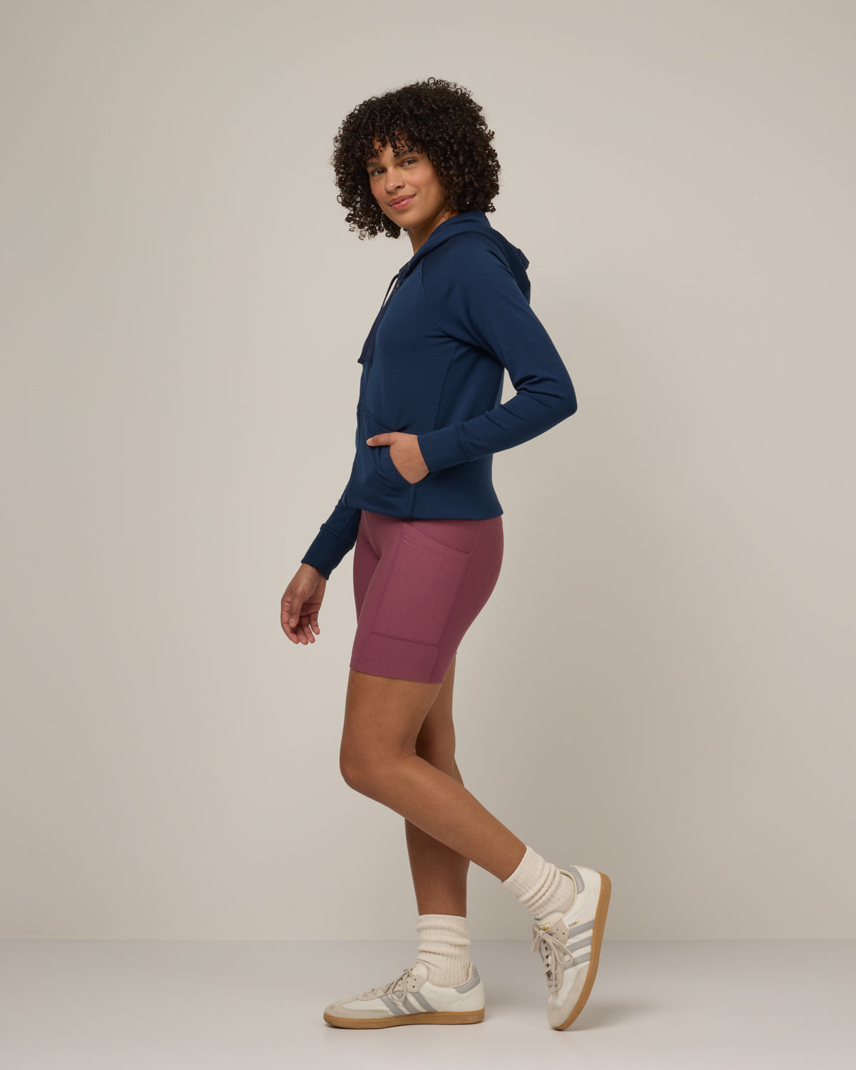 Model wearing Aspen Full-Zip Hoodie in Marine Blue, a deep royal blue color. Aspen Full-Zip Hoodie is a merino wool long sleevezip hoodie with pockets available in sizes XS-3X.