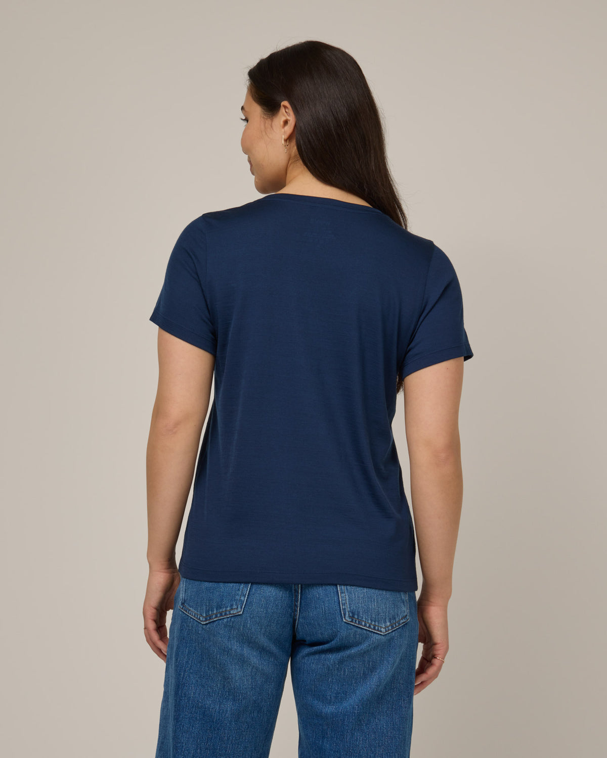 Model wearing Zoe Easy Crew Neck Tee in Marine Blue, a deep royal blue color. Zoe Easy Crew Neck Tee is a merino wool short sleeve, crew neck, regular fit tee available in sizes XS-3X.