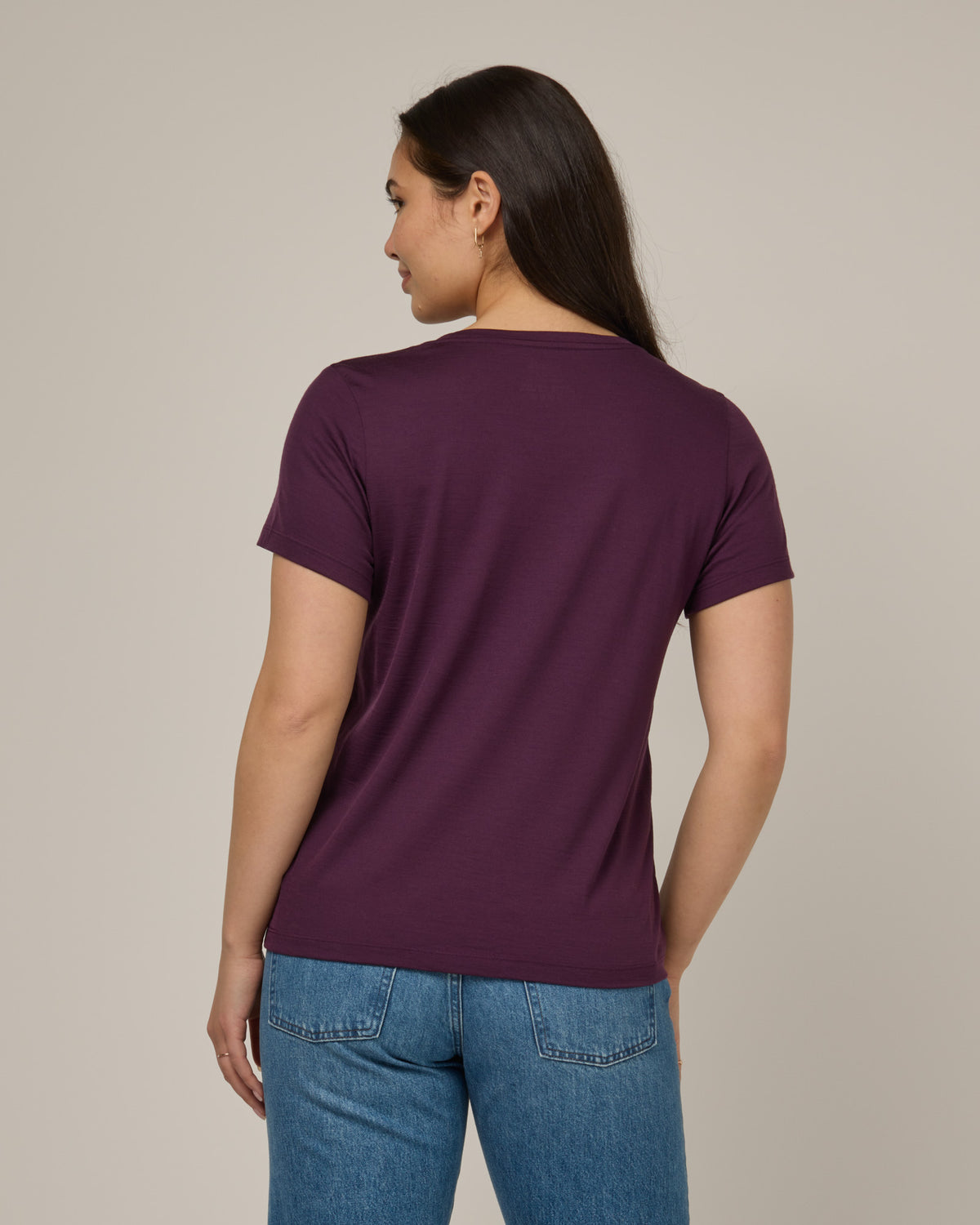 Model wearing Zoe Easy Crew Neck Tee in Marionberry, a dark berry purple color. Zoe Easy Crew Neck Tee is a merino wool short sleeve, crew neck, regular fit tee available in sizes XS-3X.