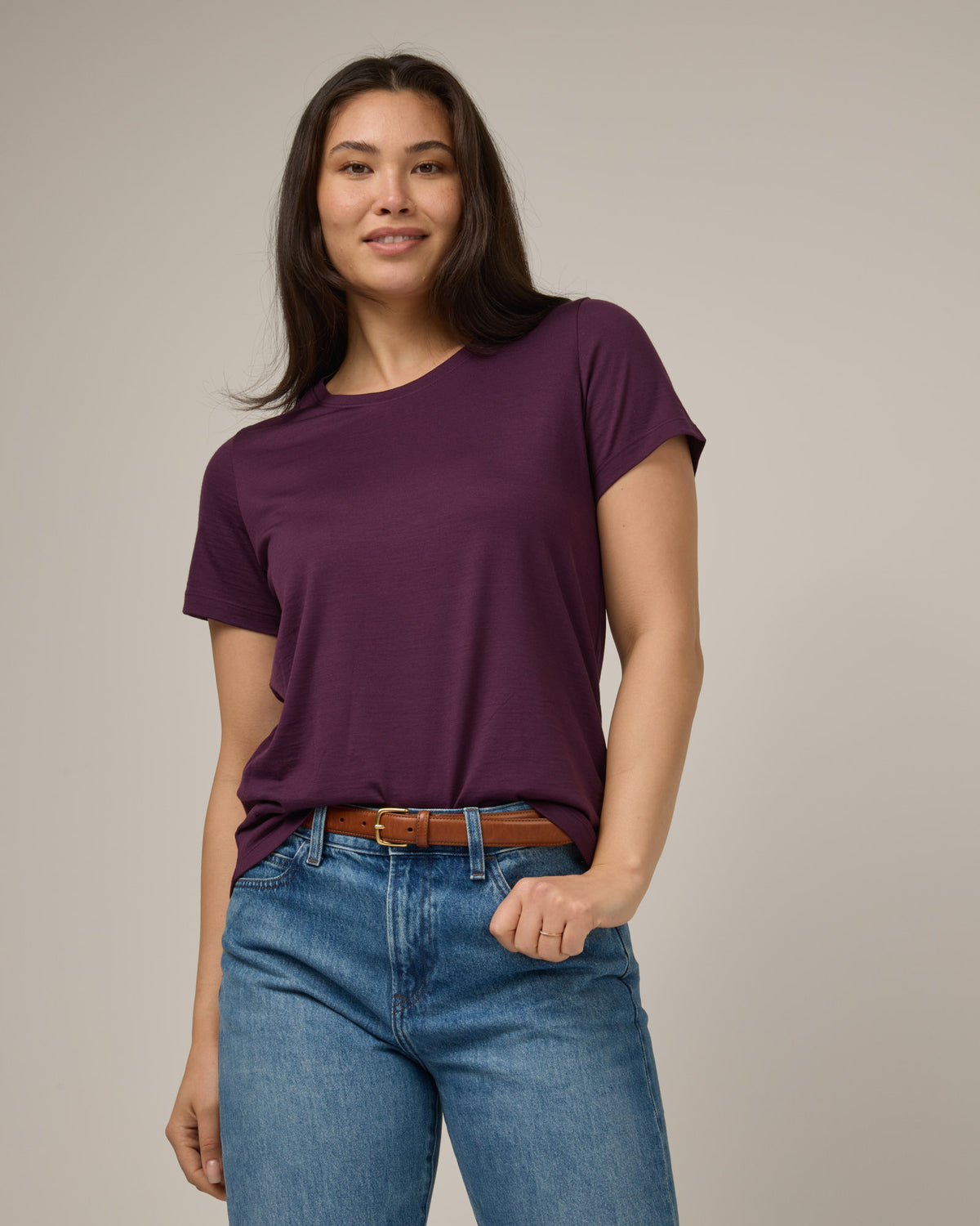 Model wearing Zoe Easy Crew Neck Tee in Marionberry, a dark berry purple color. Zoe Easy Crew Neck Tee is a merino wool short sleeve, crew neck, regular fit tee available in sizes XS-3X.
