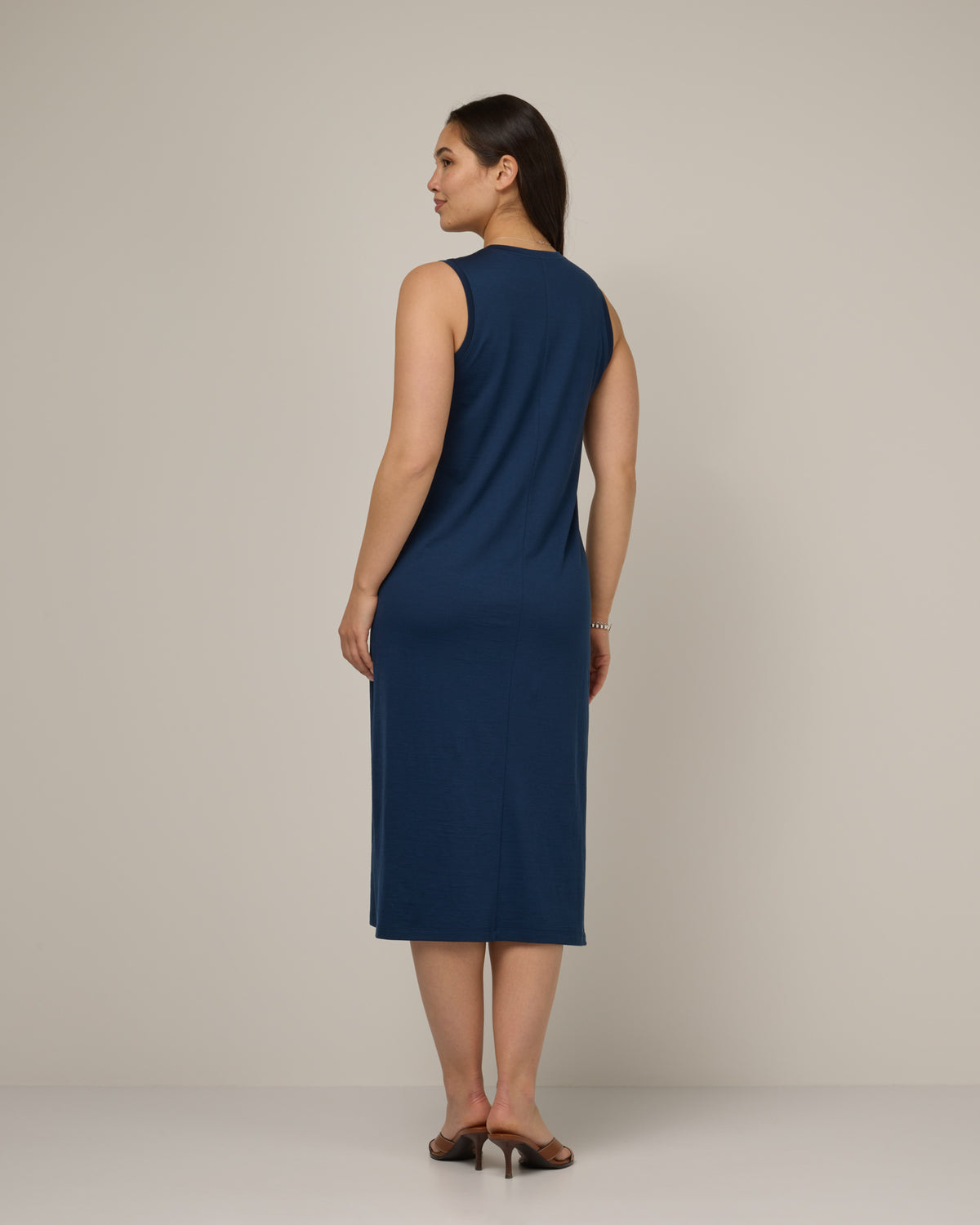 Model wearing Milena Shift Dress in Marine Blue, a deep royal blue color. Milena Shift Dress is a merino wool sleeveless, v-neck, midi shift dress available in sizes XS-3X regular, XS-XL petite.