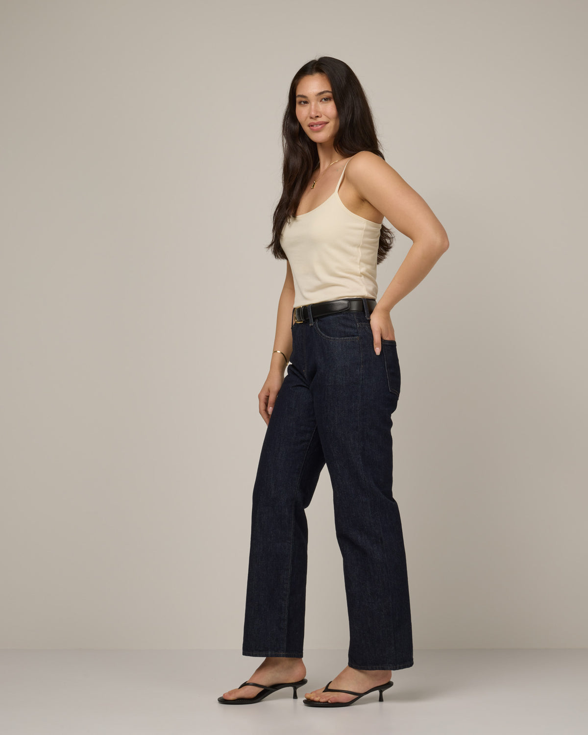 Model wearing Roam Shelf Bra Cami in Natural White, an off-white cream color. Roam Shelf Bra Cami is a merino wool sleeveless, scoop neck, slim fit top available in sizes XS-XXL.