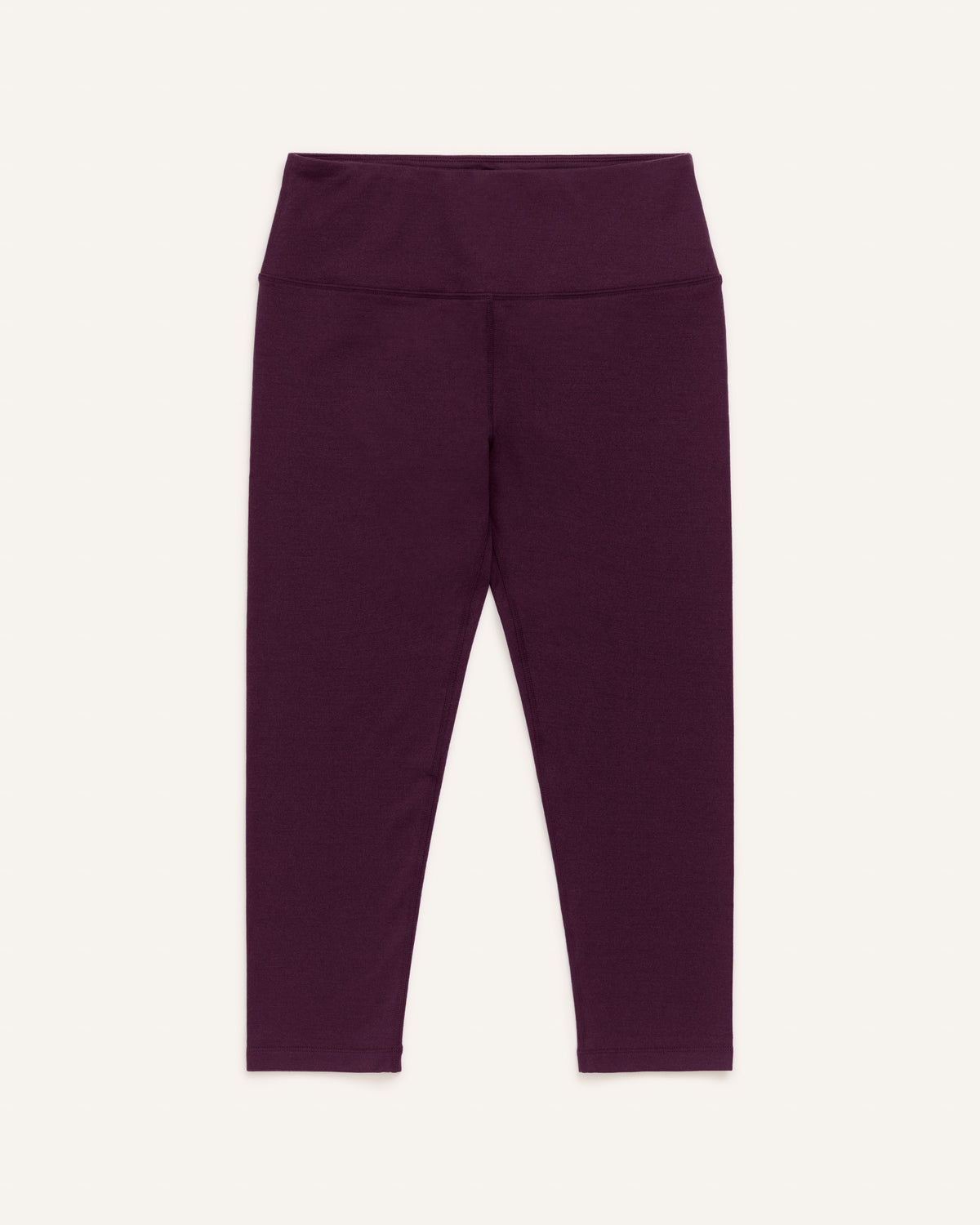 Laydown of Summit Crop Legging in Dark Marionberry, a deep berry purple color. Summit Crop Legging is a merino wool legging available in sizes XS-3X.