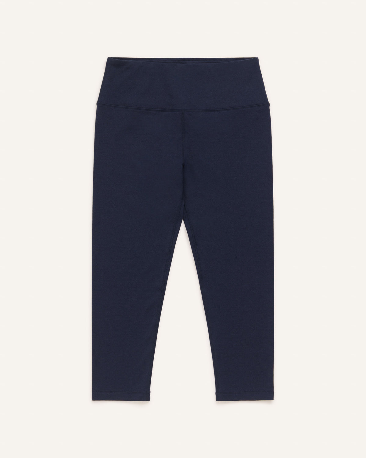 Laydown of Summit Crop Legging in Navy. Summit Crop Legging is a merino wool legging available in sizes XS-3X.