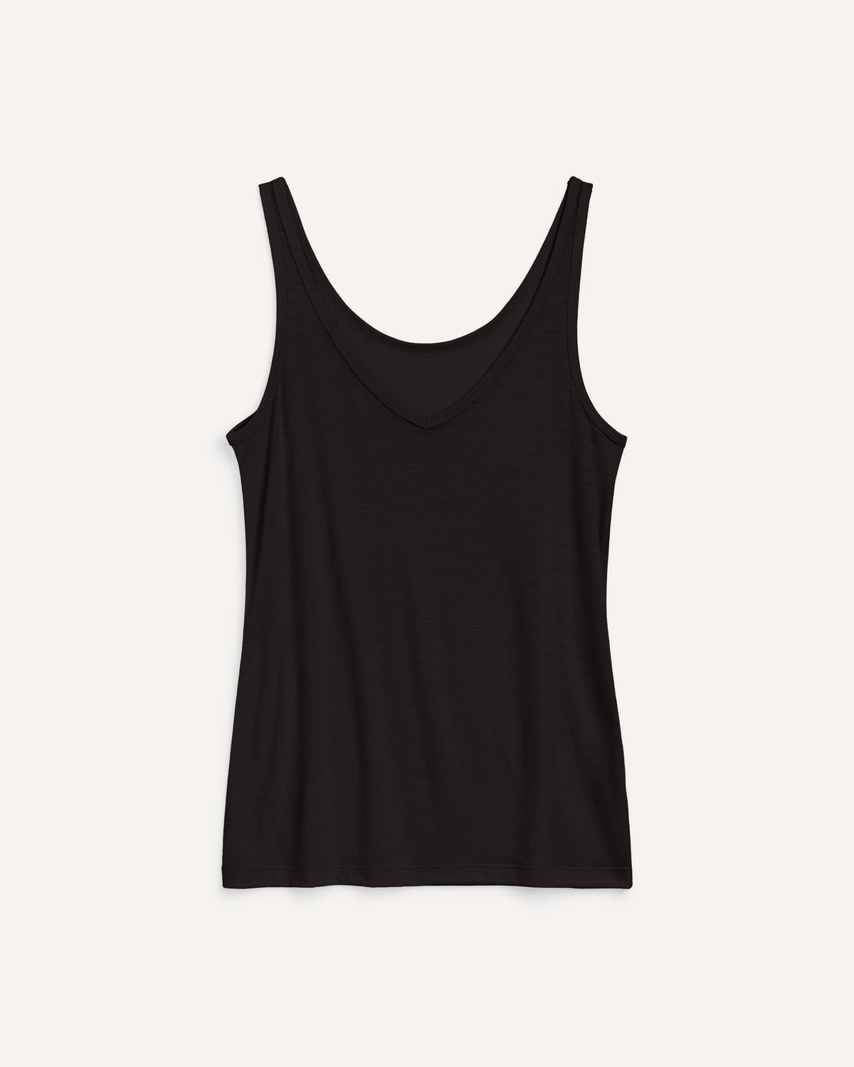 Laydown of Essential Layering Tank in Black. Essential Layering Tank is a merino wool sleeveless, reversible, slim fit top available in sizes XS-3X.