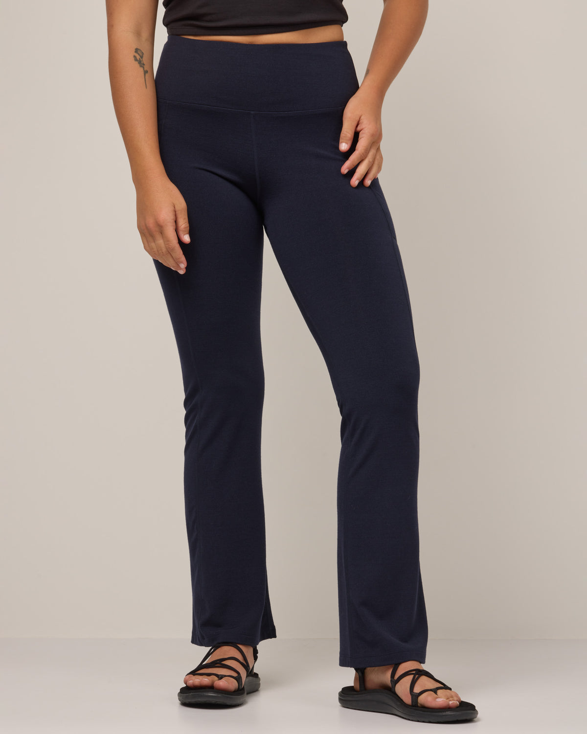 Model wearing Summit Straight Cut Pocket Legging in Navy. Summit Straight Cut Pocket Legging is a merino wool legging with pockets available in sizes XS-3X Regular, S-XXL Long.