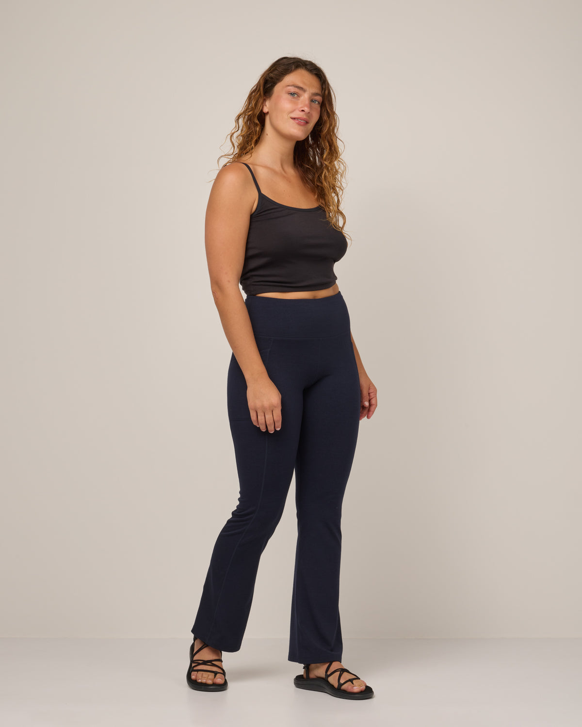 Model wearing Summit Straight Cut Pocket Legging in Navy. Summit Straight Cut Pocket Legging is a merino wool legging with pockets available in sizes XS-3X Regular, S-XXL Long.